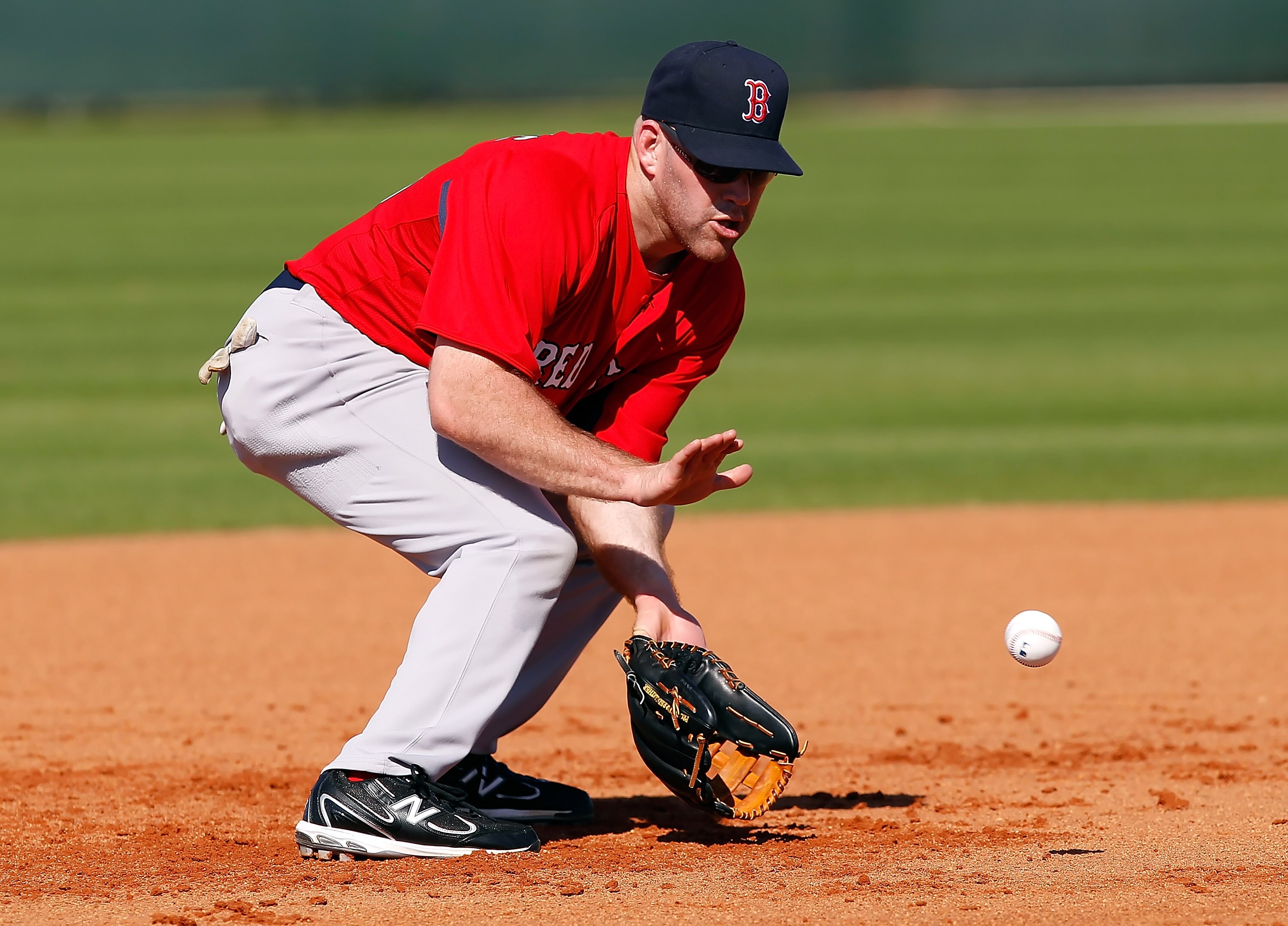 FORT MYERS, FL - FEBRUARY 19:  Infielder Kevin Youkilis #20 of the Boston Red Sox fields a ground ball during a Spring Training Workout Session at the Red Sox Player Development Complex on February 19, 2011 in Fort Myers, Florida.  (Photo by J. Meric/Gett