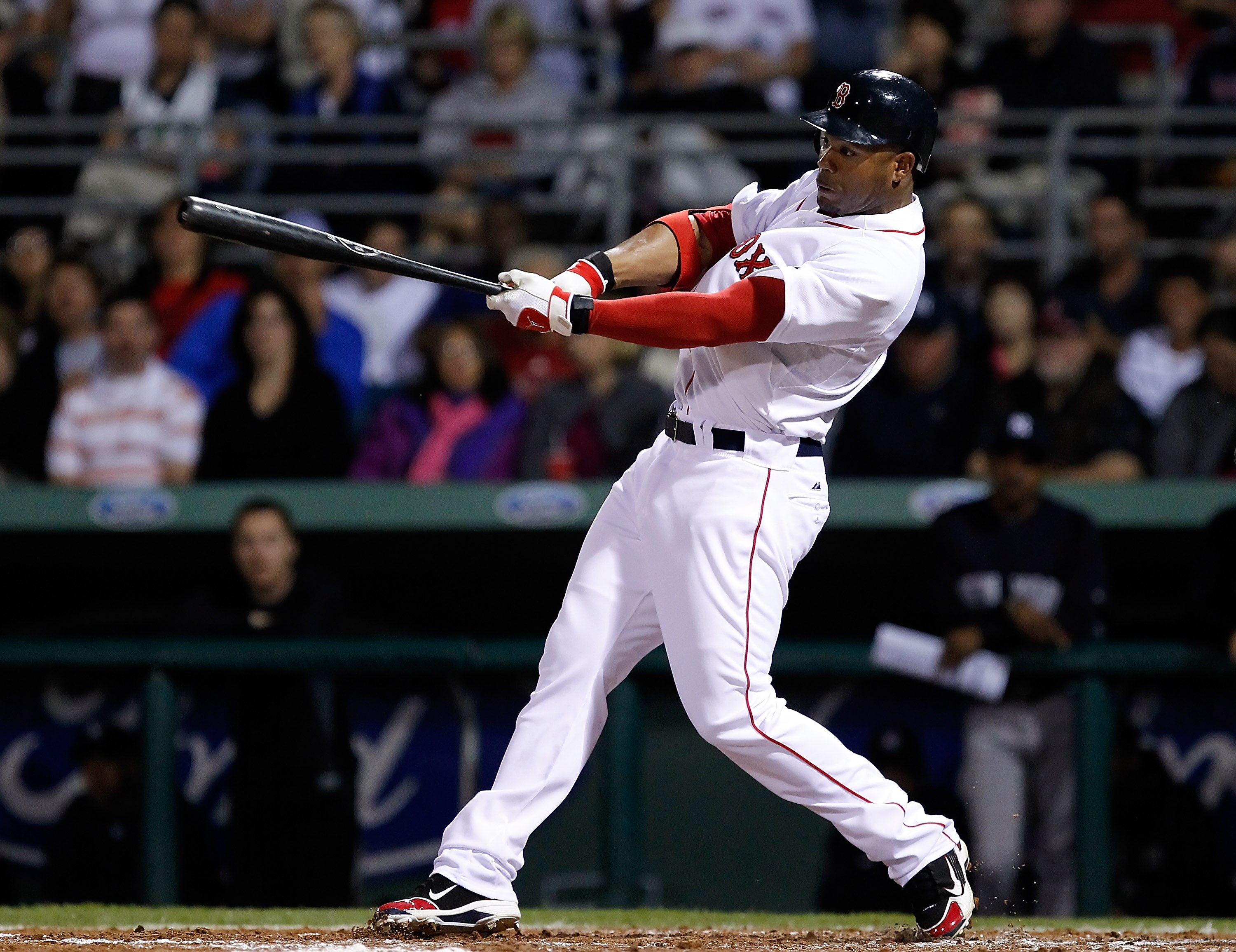 FORT MYERS, FL - MARCH 14:  Outfielder Carl Crawford #13 of the Boston Red Sox fouls off a pitch against the New York Yankees during a Grapefruit League Spring Training Game at City of Palms Park on March 14, 2011 in Fort Myers, Florida.  (Photo by J. Mer