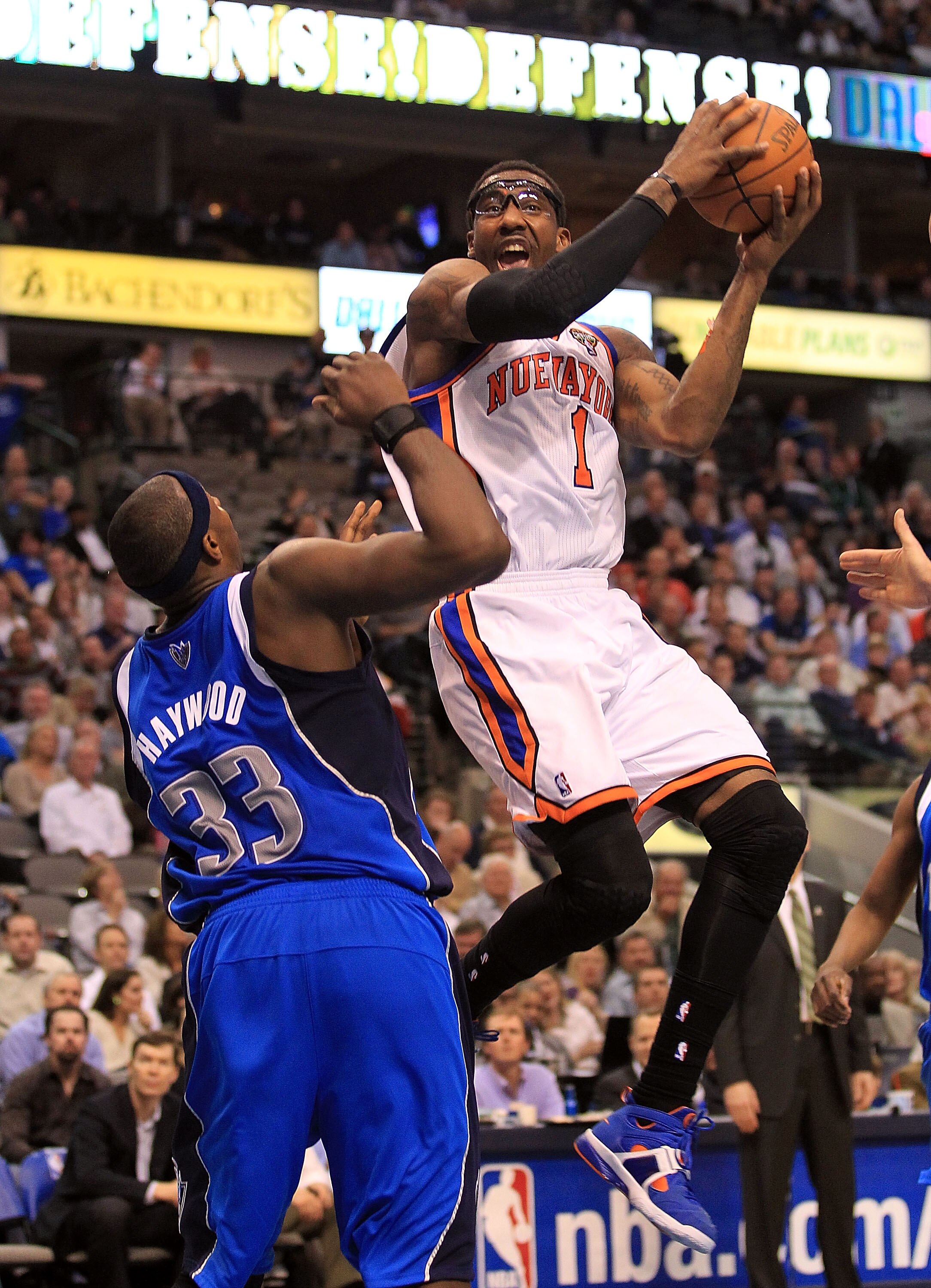 DALLAS, TX - MARCH 10: Amar'e Stoudemire #1 of the New York Knicks takes a shot against Brendan Haywood #33 of the Dallas Mavericks at American Airlines Center on March 10, 2011 in Dallas, Texas. NOTE TO USER: User expressly acknowledges and agrees that DALLAS, TX - MARCH 10: Amar'e Stoudemire #1 of the New York Knicks takes a shot against Brendan Haywood #33 of the Dallas Mavericks at American Airlines Center on March 10, 2011 in Dallas, Texas. NOTE TO USER: User expressly acknowledges and agrees that