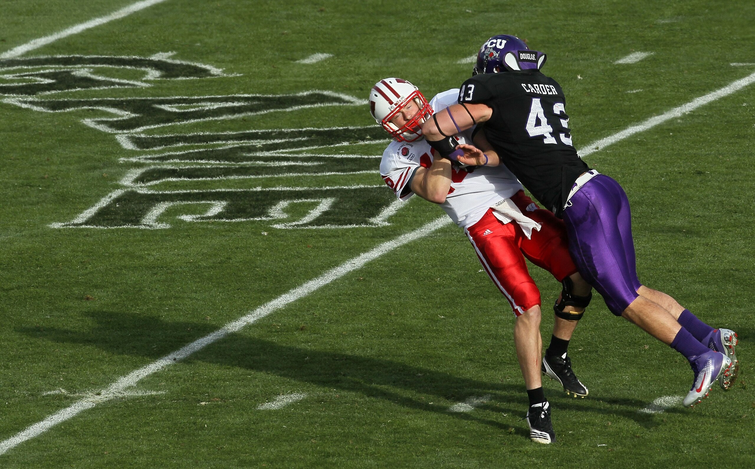 PASADENA, CA - JANUARY 01: Quarterback Scott Tolzien #16 of the Wisconsin Badgers is hit by linebacker Tank Carder #43 of the TCU Horned Frogs during the 97th Rose Bowl game on January 1, 2011 in Pasadena, California. (Photo by Stephen Dunn/Getty Images PASADENA, CA - JANUARY 01: Quarterback Scott Tolzien #16 of the Wisconsin Badgers is hit by linebacker Tank Carder #43 of the TCU Horned Frogs during the 97th Rose Bowl game on January 1, 2011 in Pasadena, California. (Photo by Stephen Dunn/Getty Images