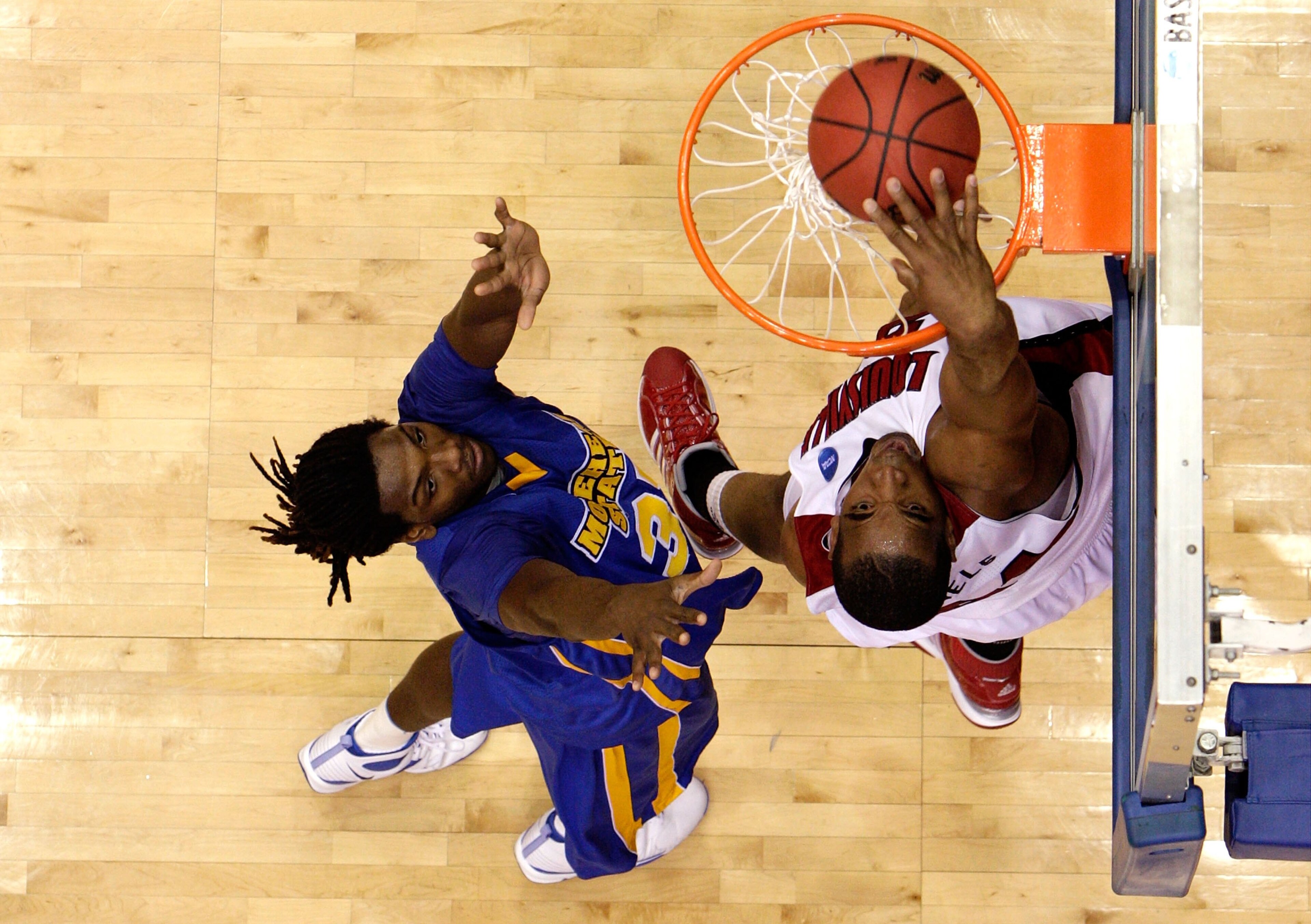 DAYTON, OH - MARCH 20: Samardo Samuels #24 of the Louisville Cardinals dunks the ball against Kenneth Faried #35 of the Morehead State Eagles during the first round of the NCAA Division I Men's Basketball Tournament at the University of Dayton Arena on Ma