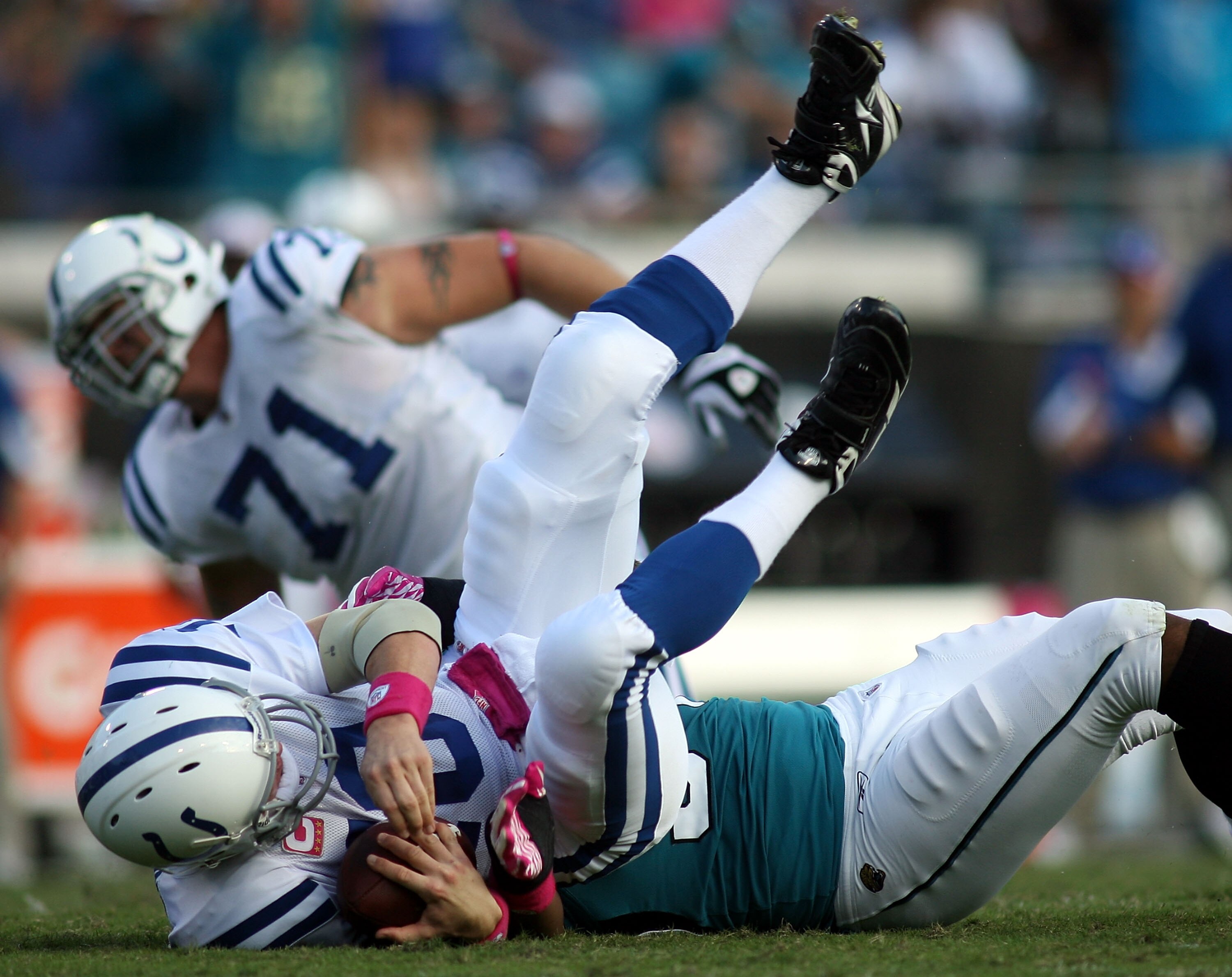 JACKSONVILLE, FL - OCTOBER 03:  Quarterback Peyton Manning #18 of the Indianapolis Colts is sacked by Lineman Jeremy Mincey #94 of the Jacksonville Jaguars at EverBank Field on October 3, 2010 in Jacksonville, Florida.  (Photo by Marc Serota/Getty Images)