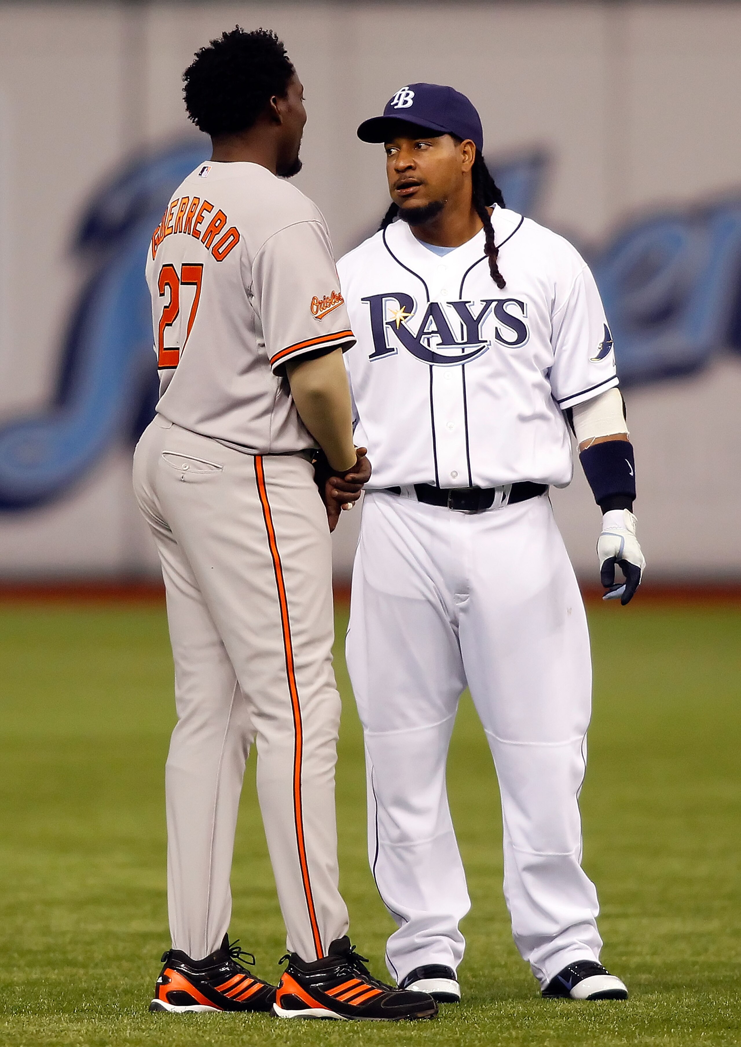 ST. PETERSBURG, FL - APRIL 02:  Designated hitter Manny Ramirez #24 of the Tampa Bay Rays talks with designated hitter Vladimir Guerrero #27 of the Baltimore Orioles just before the start of the game at Tropicana Field on April 2, 2011 in St. Petersburg,