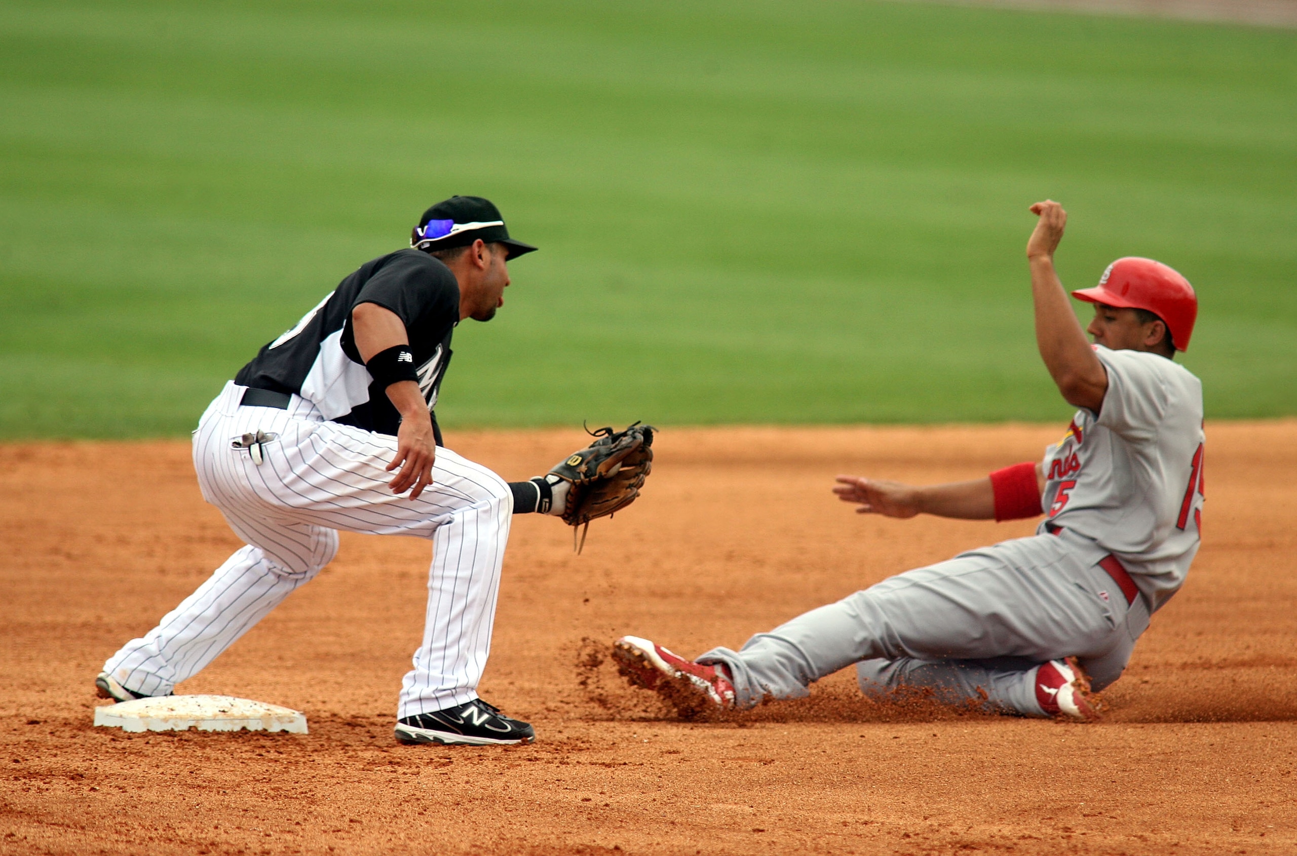 JUPITER, FL - MARCH 06: Second baseman Omar Infante #13 of the of the Florida Marlin catches Jon Jay #22 of the St. Louis Cardinals stealing at Roger Dean Stadium on March 6, 2011 in Jupiter, Florida.  (Photo by Marc Serota/Getty Images)
