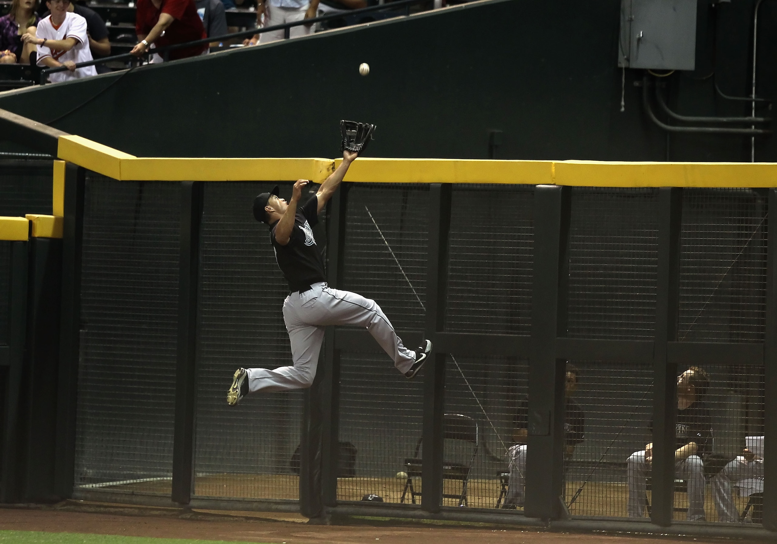 PHOENIX - JULY 08:  Outfielder Mike Stanton #27 of the Florida Marlins leaps as he attempts to catch a 2 RBI triple hit by Kelly Johnson (not pictured) of the Arizona Diamondbacks during the fourth inning of the Major League Baseball game at Chase Field o
