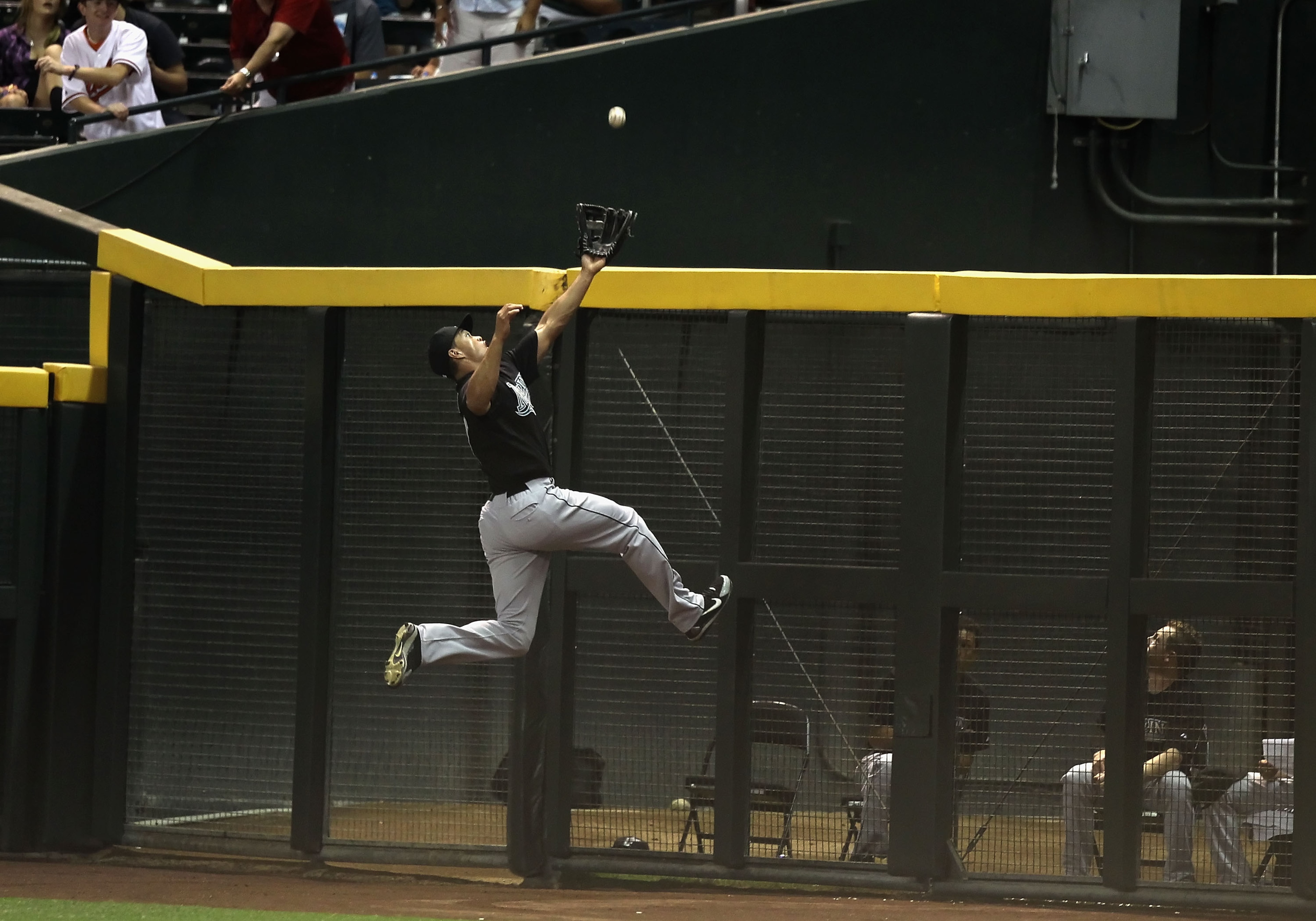 PHOENIX - JULY 08:  Outfielder Mike Stanton #27 of the Florida Marlins leaps as he attempts to catch a 2 RBI triple hit by Kelly Johnson (not pictured) of the Arizona Diamondbacks during the fourth inning of the Major League Baseball game at Chase Field o
