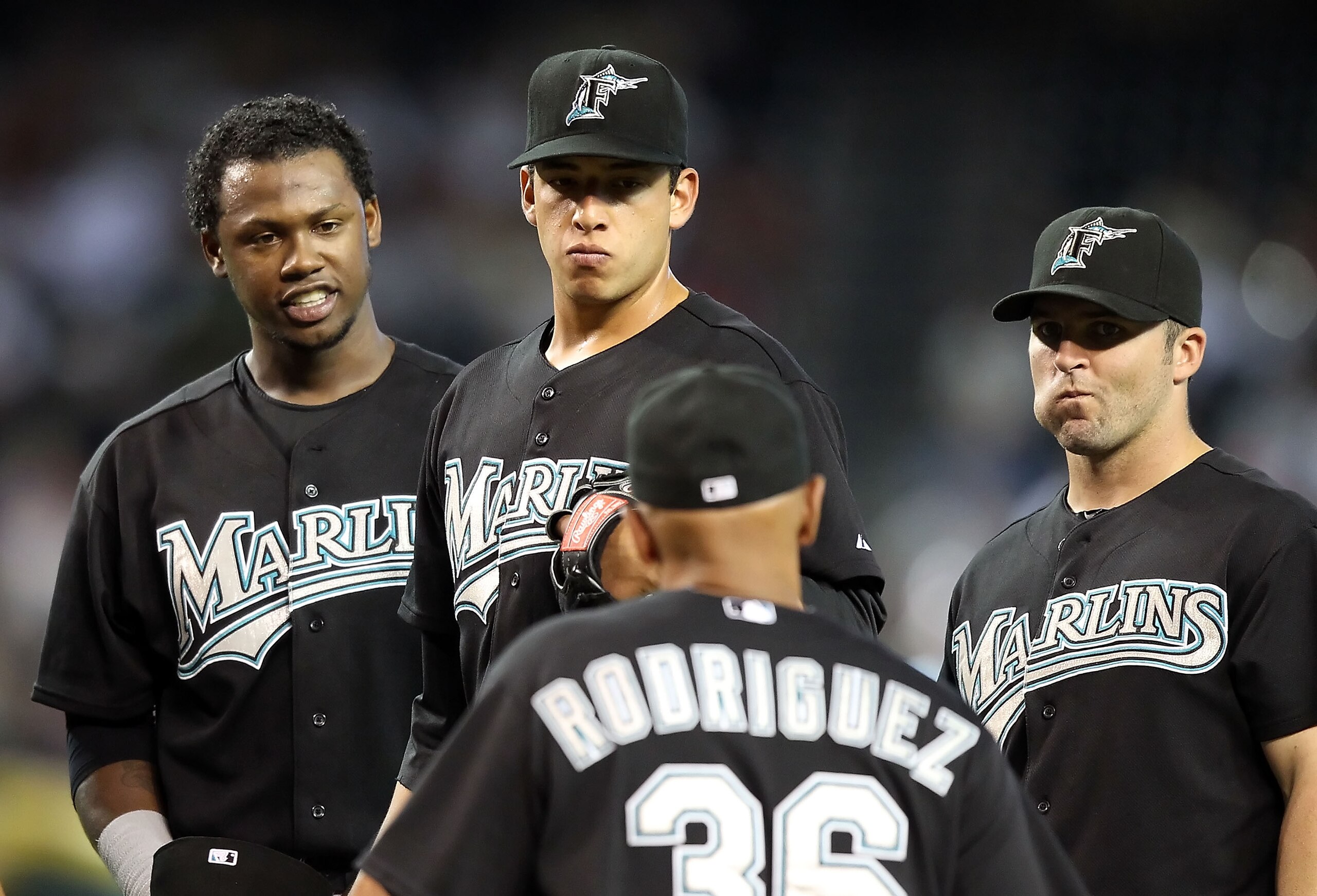 PHOENIX - JULY 11:  Infielder Hanley Ramirez #2, pitcher Alex Sanabia #59 and Dan Uggla #6 of the Florida Marlins stand on the mound as manager Edwin Rodriguez #36 walks up during the Major League Baseball game against the Arizona Diamondbacks at Chase Fi