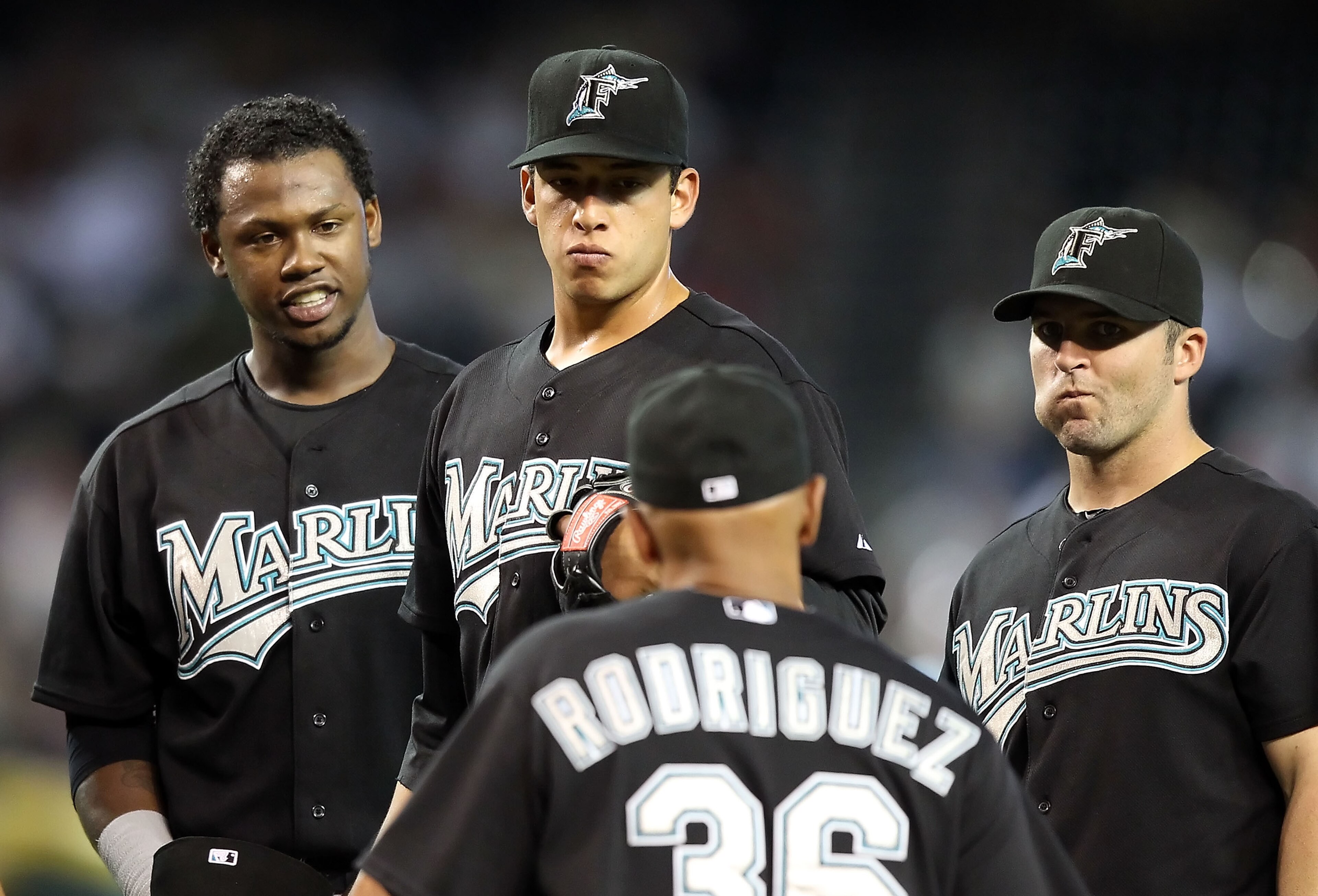 PHOENIX - JULY 11:  Infielder Hanley Ramirez #2, pitcher Alex Sanabia #59 and Dan Uggla #6 of the Florida Marlins stand on the mound as manager Edwin Rodriguez #36 walks up during the Major League Baseball game against the Arizona Diamondbacks at Chase Fi