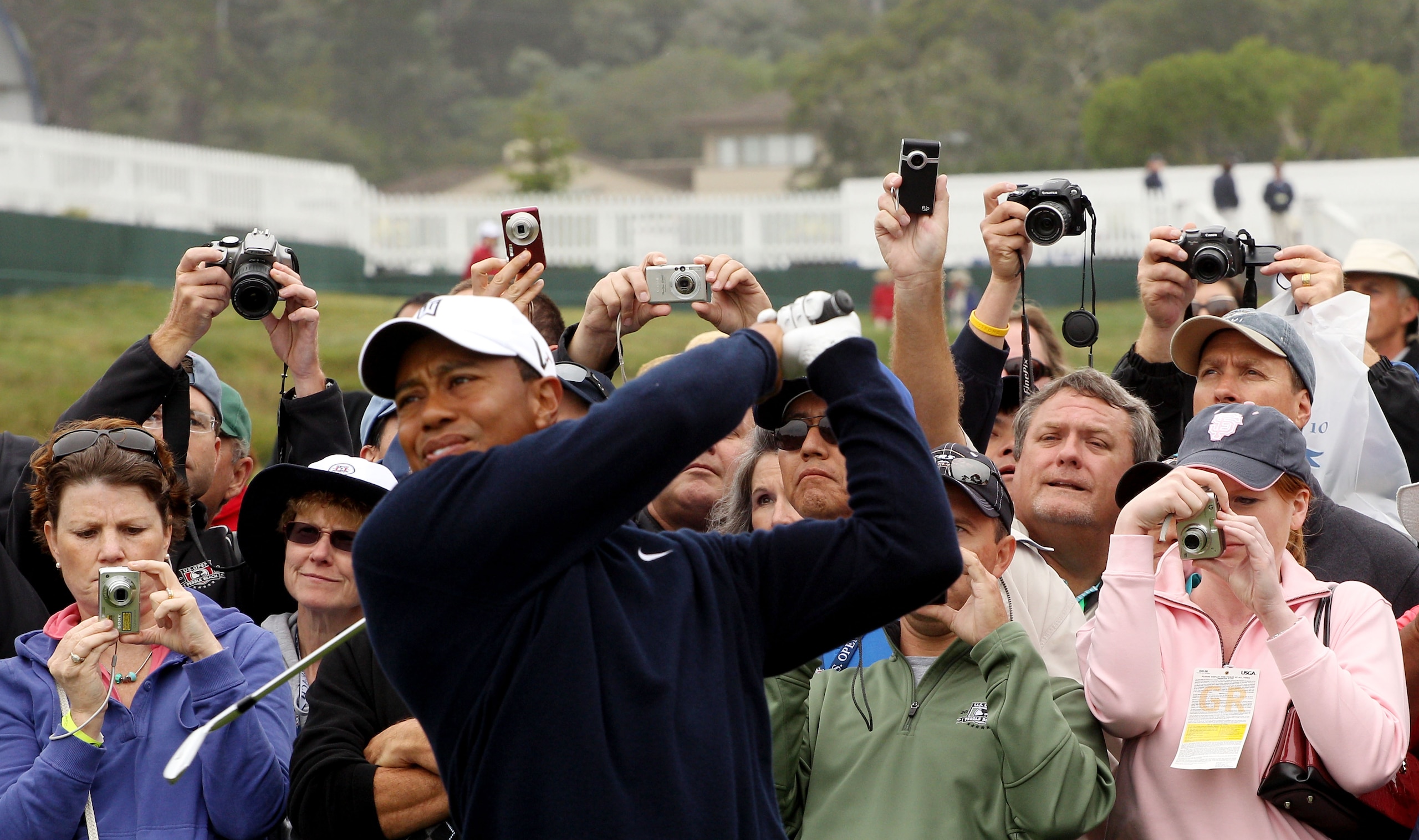 PEBBLE BEACH, CA - JUNE 14:  Patrons photograph Tiger Woods as he plays a tee shot during a practice round prior to the start of the 110th U.S. Open at Pebble Beach Golf Links on June 14, 2010 in Pebble Beach, California.  (Photo by Scott Halleran/Getty I