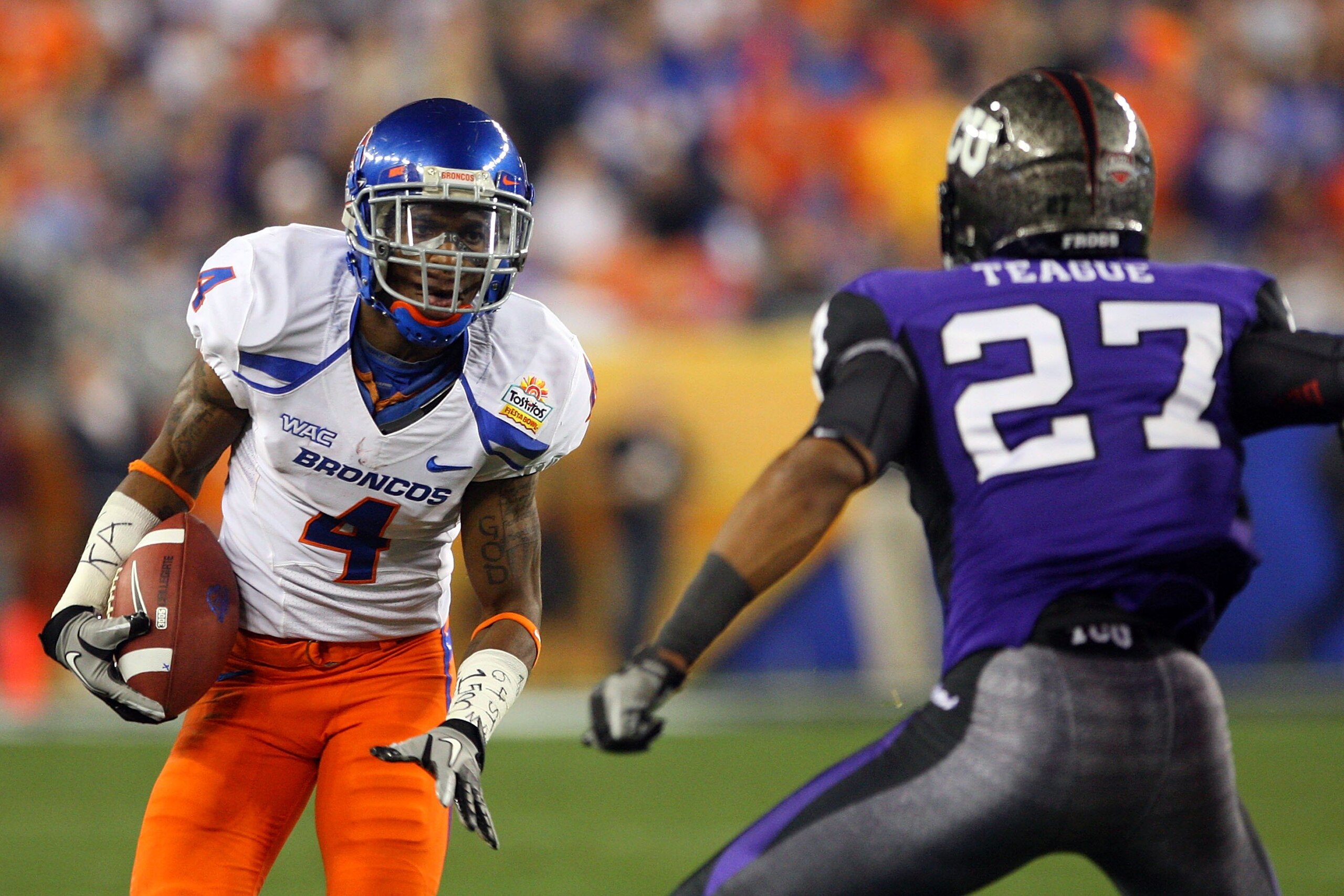 GLENDALE, AZ - JANUARY 04:  Titus Young #4 of the Boise State Broncos runs after a catch against Jason Teague #27 of the TCU Horned Frogs during the Tostitos Fiesta Bowl at the Universtity of Phoenix Stadium on January 4, 2010 in Glendale, Arizona.  (Phot