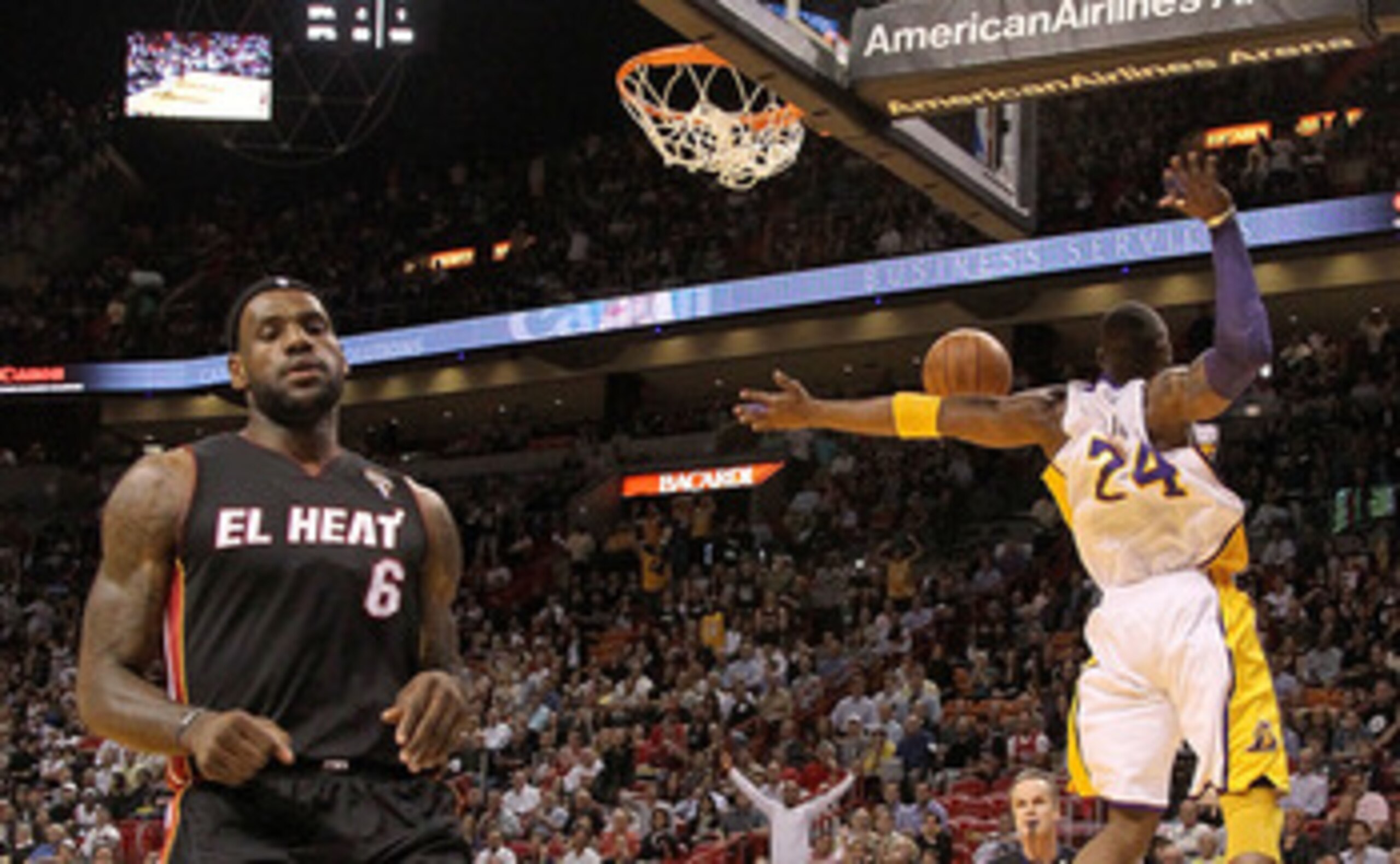 MIAMI, FL - MARCH 10:  Kobe Bryant #24 of the Los Angeles Lakers dunks as LeBron James #6 of the Miami Heat looks on during a game at American Airlines Arena on March 10, 2011 in Miami, Florida. NOTE TO USER: User expressly acknowledges and agrees that, b