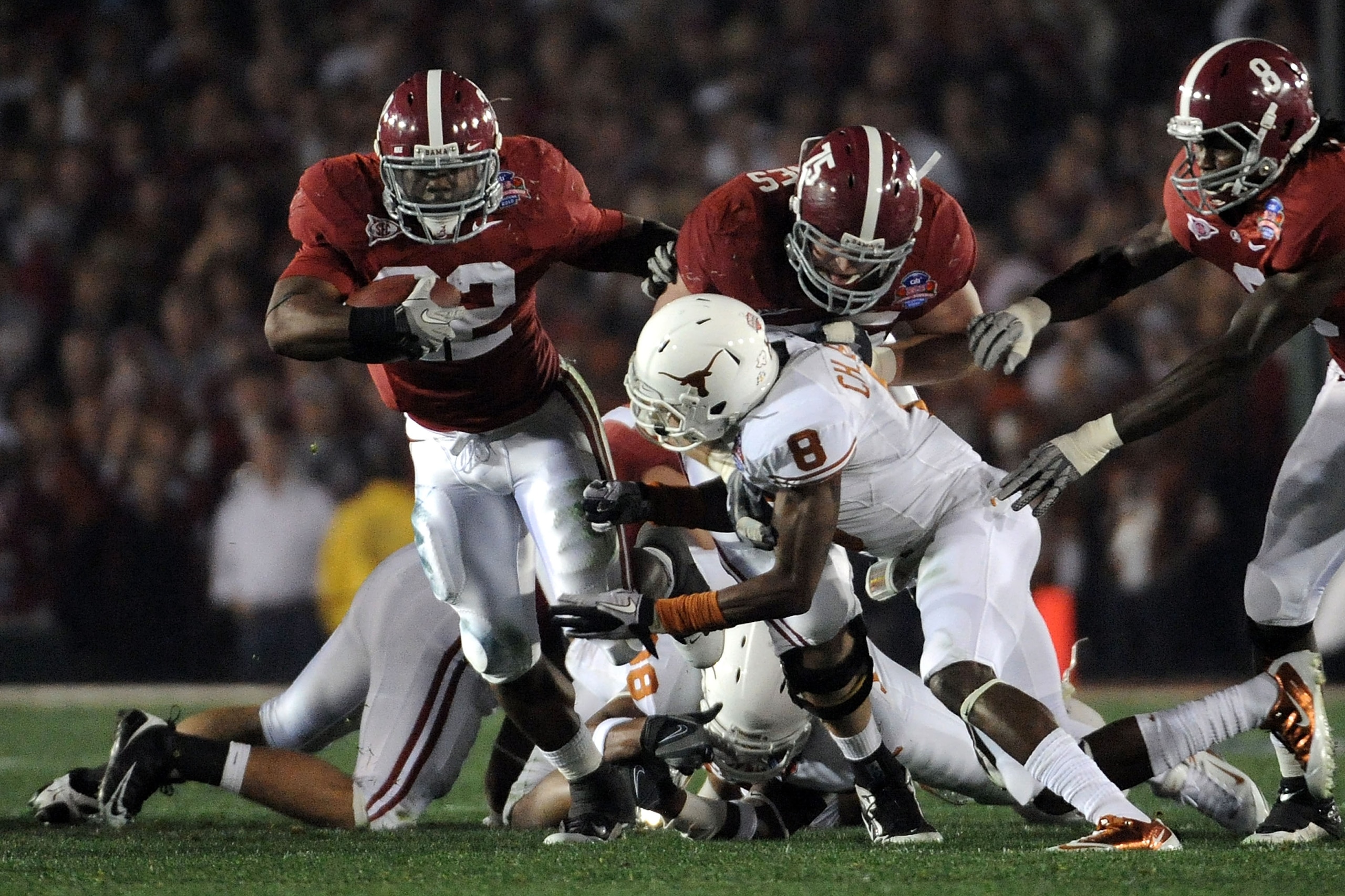 PASADENA, CA - JANUARY 07:  Running back Mark Ingram #22 of the Alabama Crimson Tide runs with the ball as Chykie Brown #3  of the Texas Longhorns tries to tackle during the Citi BCS National Championship game at the Rose Bowl on January 7, 2010 in Pasade