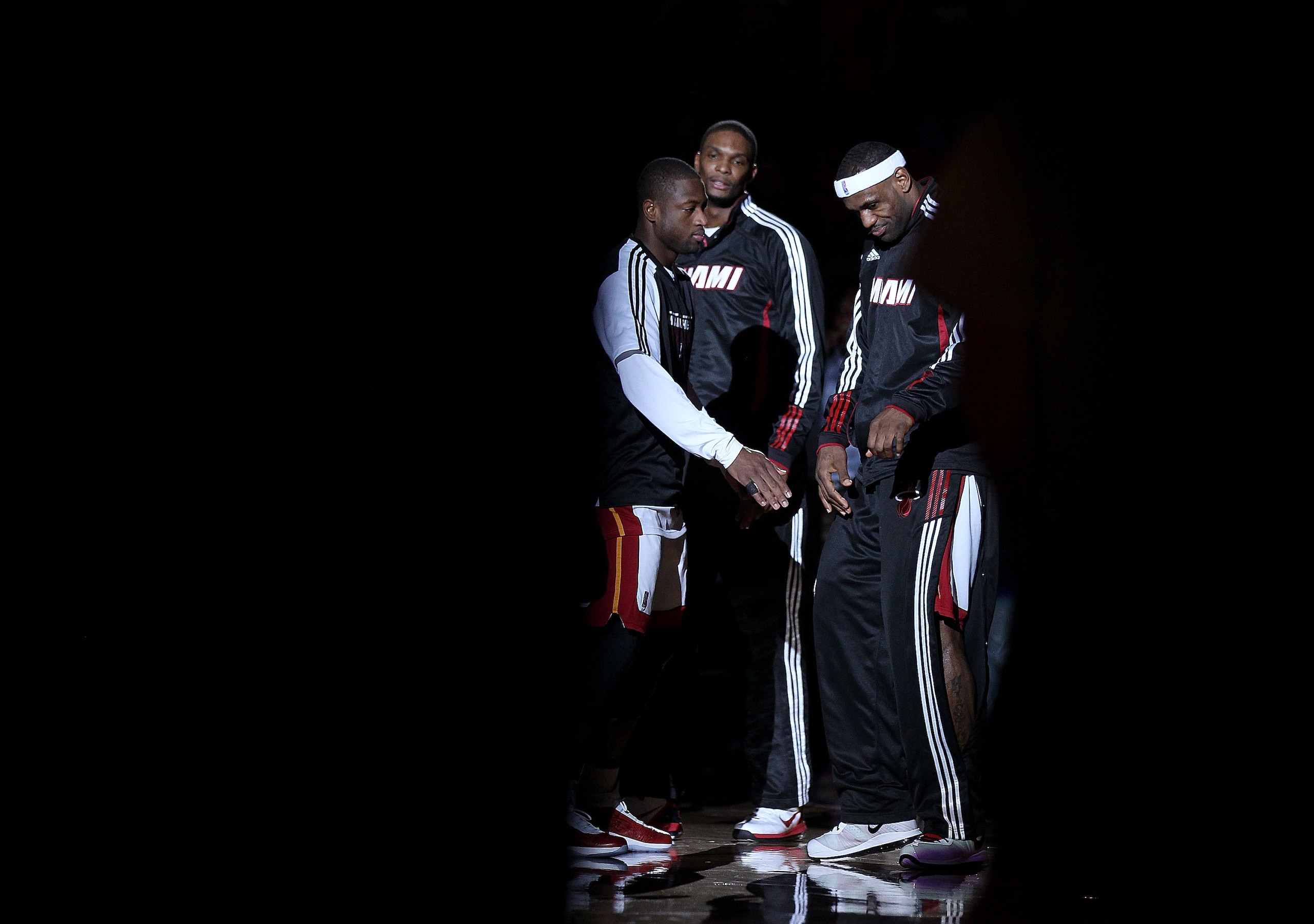 MIAMI, FL - FEBRUARY 25:  LeBron James #6, Dwyane Wade #3 and Chris Bosh #1 of the Miami Heat talk during a game against the Washington Wizards at American Airlines Arena on February 25, 2011 in Miami, Florida. NOTE TO USER: User expressly acknowledges an