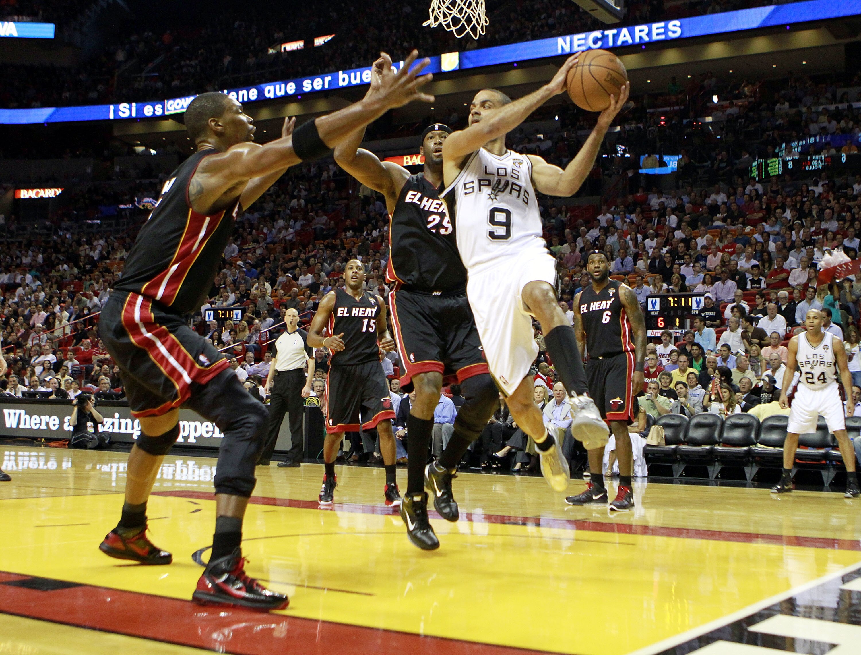 MIAMI - MARCH 14:  Guard Tony Parker #9 of the San Antonio Spurs drives on Dwyane Wade #3 of the Miami Heat at American Airlines Arena on March 14, 2011 in Miami, Florida. NOTE TO USER: User expressly acknowledges and agrees that, by downloading and/or us