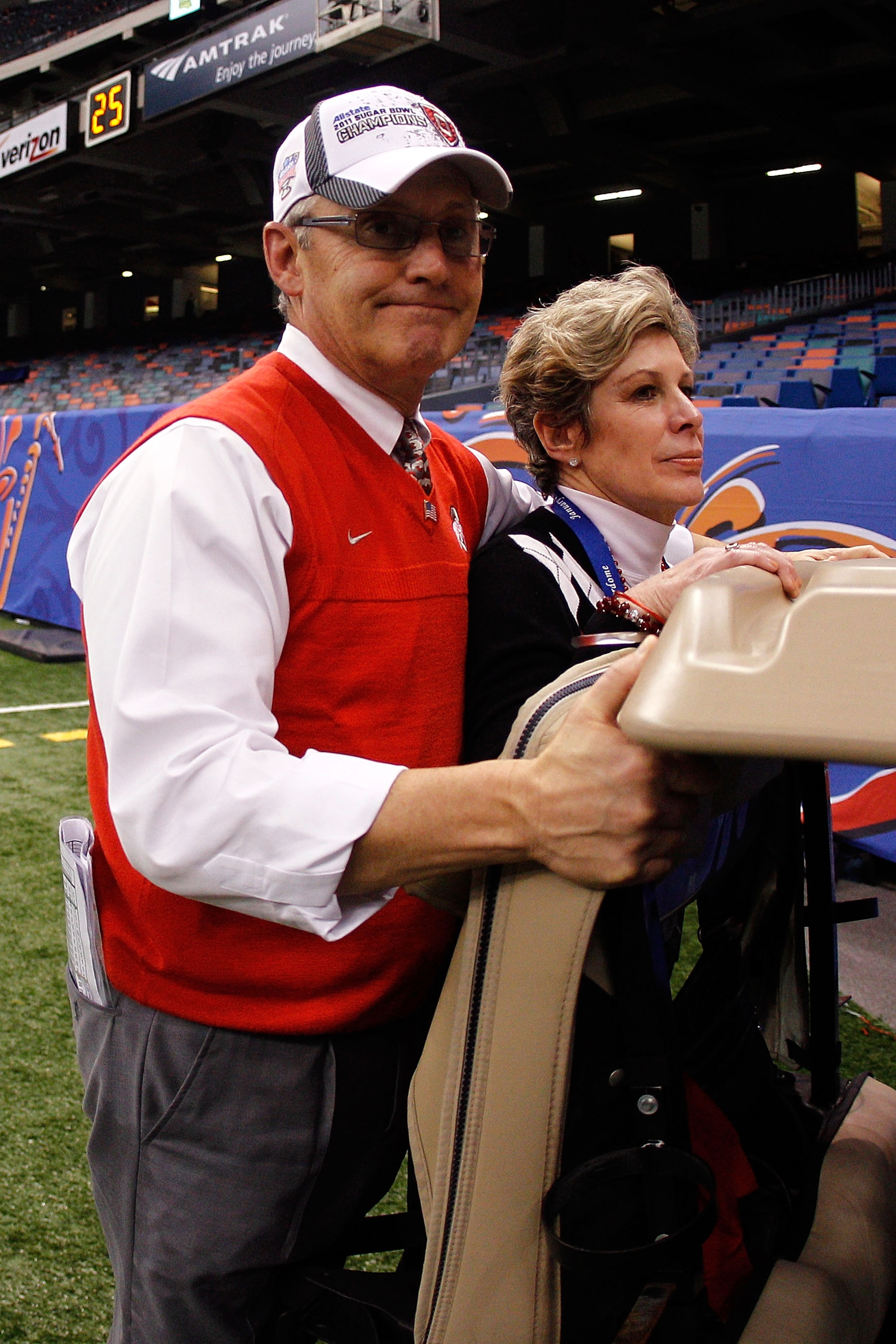 NEW ORLEANS, LA - JANUARY 04:  Head coach Jim Tressel of the Ohio State Buckeyes and wife Ellen Tressel are carted off the field after the Buckeyes 31-26 victory against the Arkansas Razorbacks during the Allstate Sugar Bowl at the Louisiana Superdome on