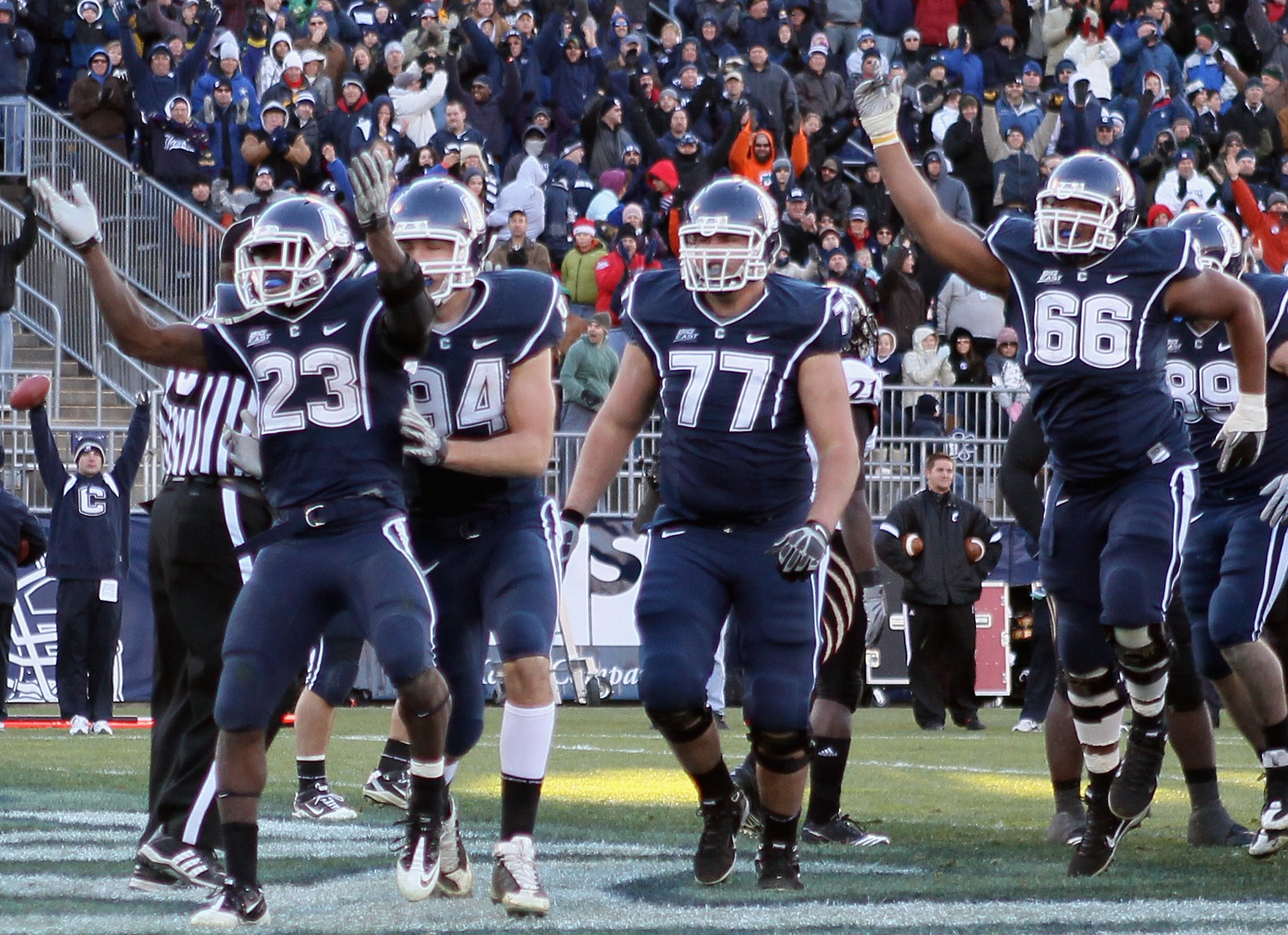 EAST HARTFORD, CT - NOVEMBER 27: Jordan Todman #23 of the Connecticut Huskies celebrates his touchdown with teammates Ryan Griffin #94, Kevin Friend #77 and Mathieu Olivier #66 in the fourth quarter against the Cincinnati Bearcats on November 27, 2010 at
