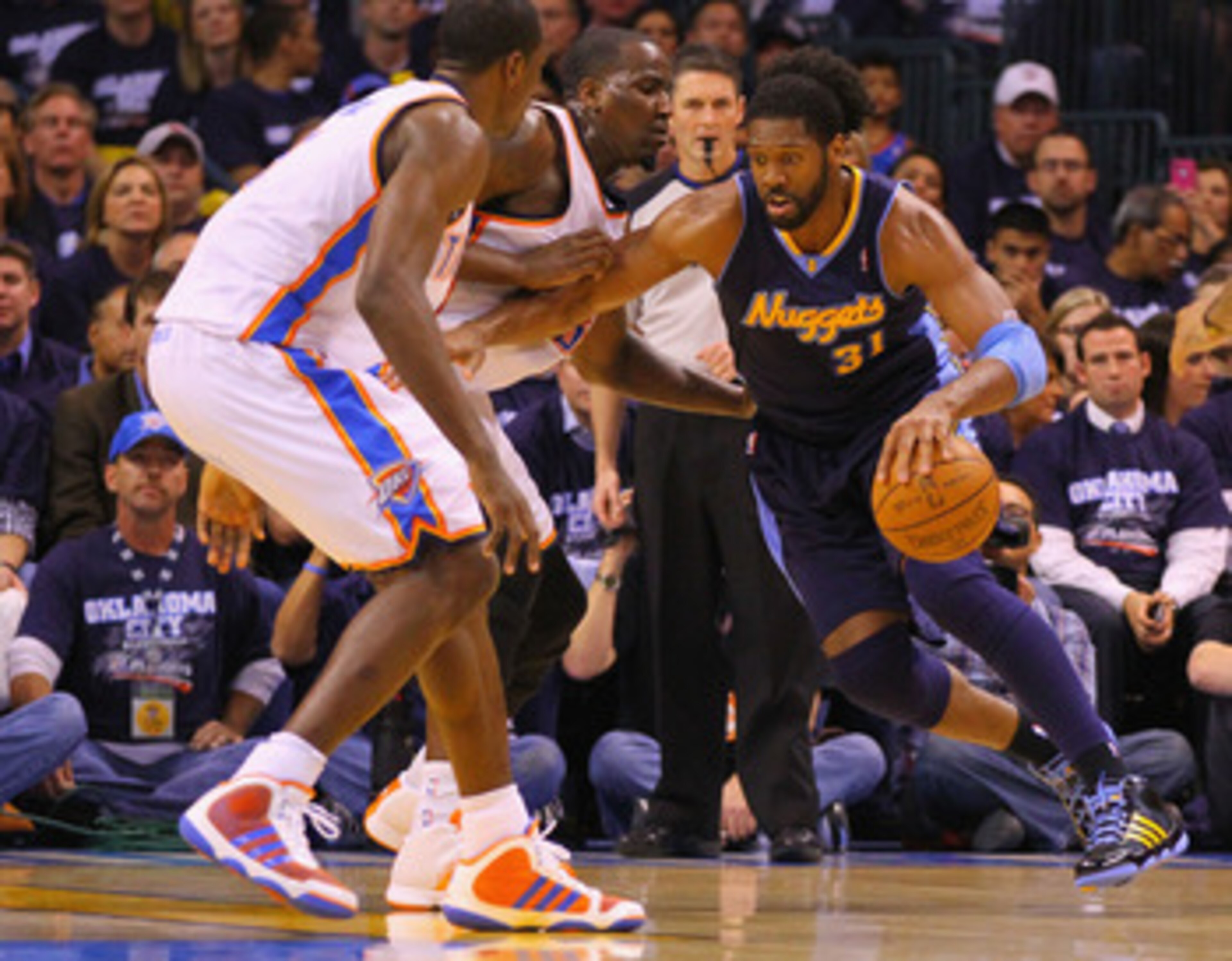 OKLAHOMA CITY, OK - APRIL 27: Nene Hilario #31 of the Denver Nuggets drives to the basket against Kendrick Perkins #5 of the Oklahoma City Thunder in Game Five of the Western Conference Quarterfinals in the 2011 NBA Playoffs on April 27, 2011 at the Ford