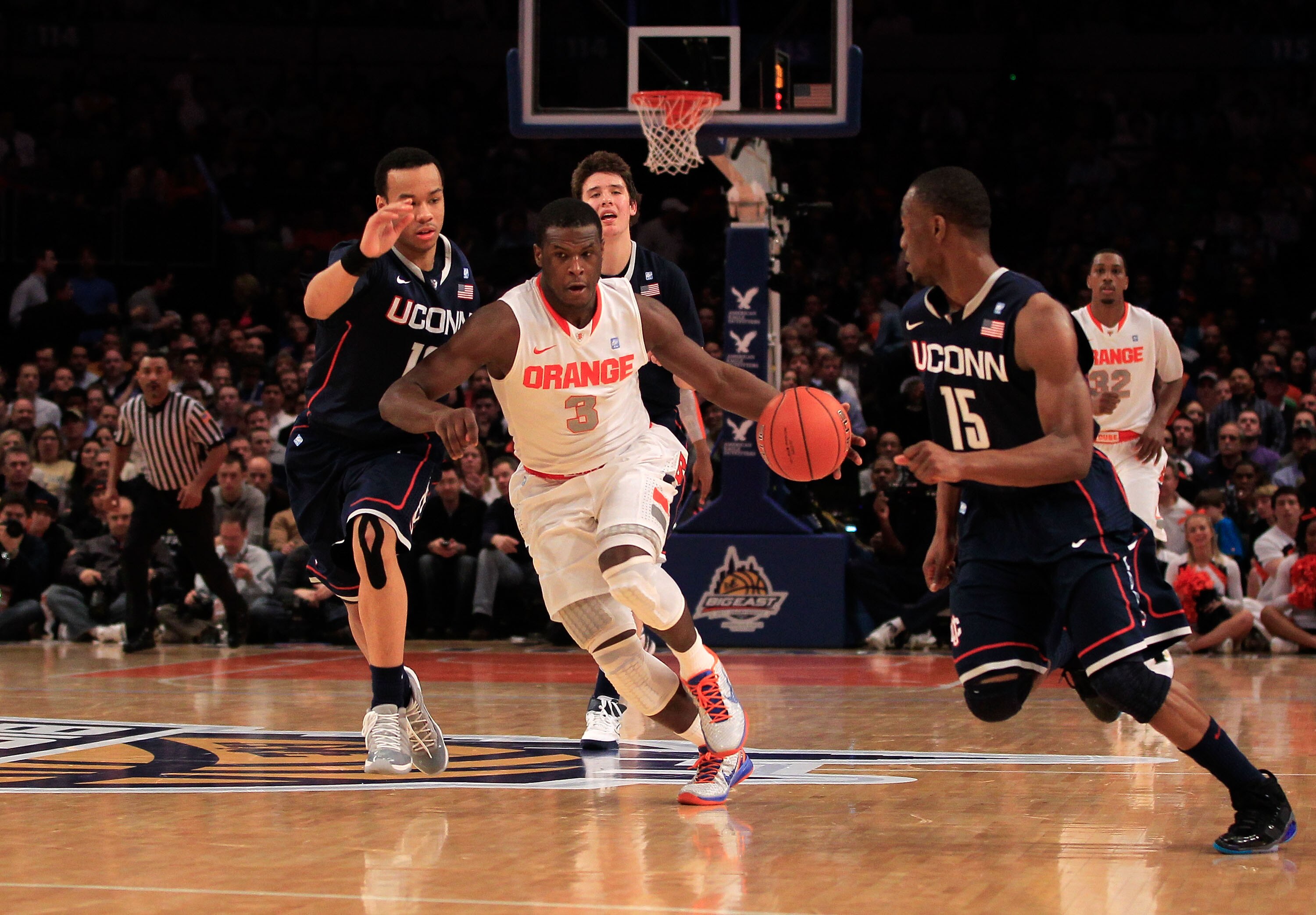 NEW YORK, NY - MARCH 11: Dion Waiters #3 of the Syracuse Orange dribbles past Shabazz Napier #13 and Kemba Walker #15 of the Connecticut Huskies during the semifinals of the 2011 Big East Men's Basketball Tournament presented by American Eagle Outfitters