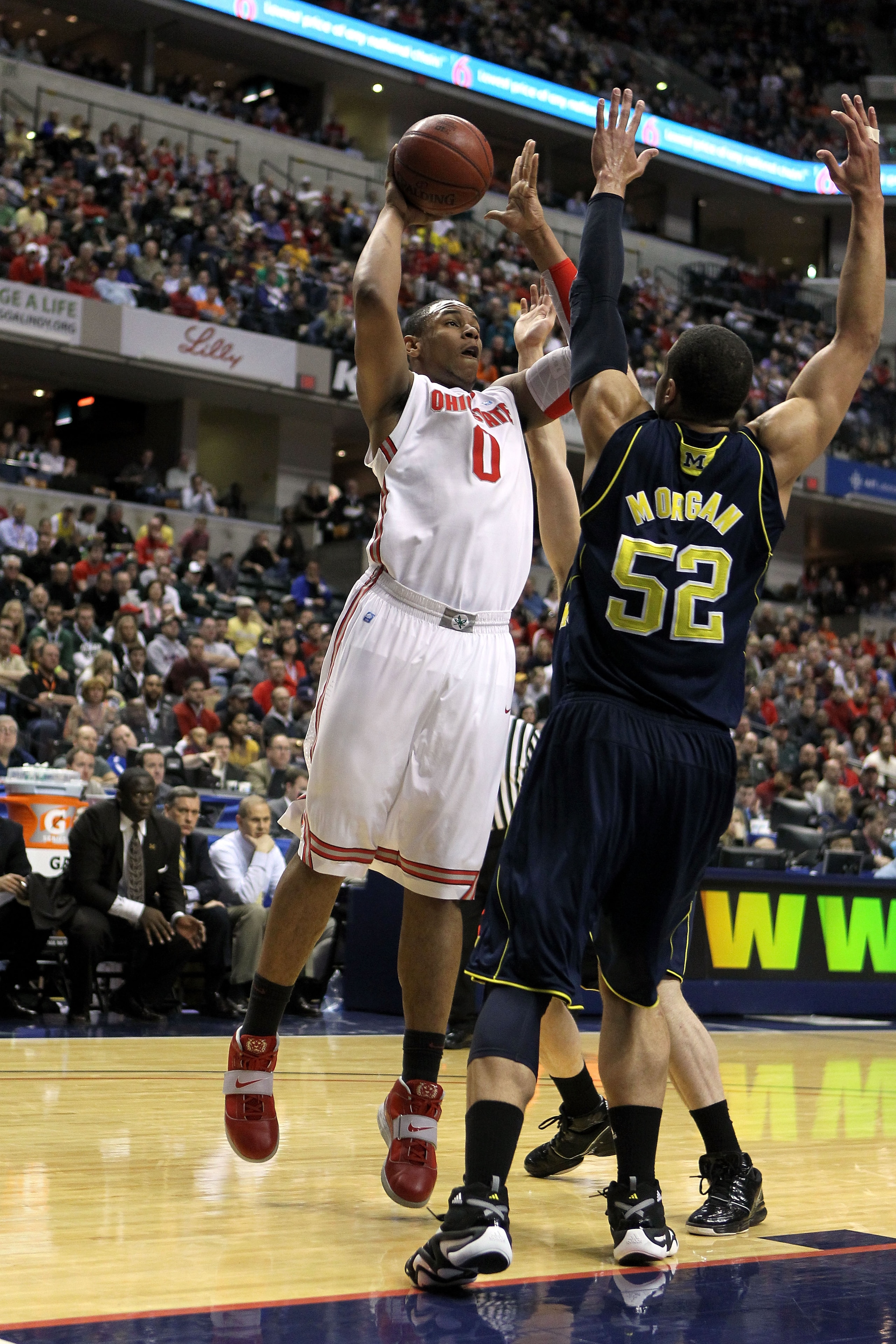 INDIANAPOLIS, IN - MARCH 12: Jared Sullinger #0 of the Ohio State Buckeyes attempts a shot against Jordan Morgan #52 of the Michigan Wolverines during the semifinals of the 2011 Big Ten Men's Basketball Tournament at Conseco Fieldhouse on March 12, 2011 INDIANAPOLIS, IN - MARCH 12: Jared Sullinger #0 of the Ohio State Buckeyes attempts a shot against Jordan Morgan #52 of the Michigan Wolverines during the semifinals of the 2011 Big Ten Men's Basketball Tournament at Conseco Fieldhouse on March 12, 2011