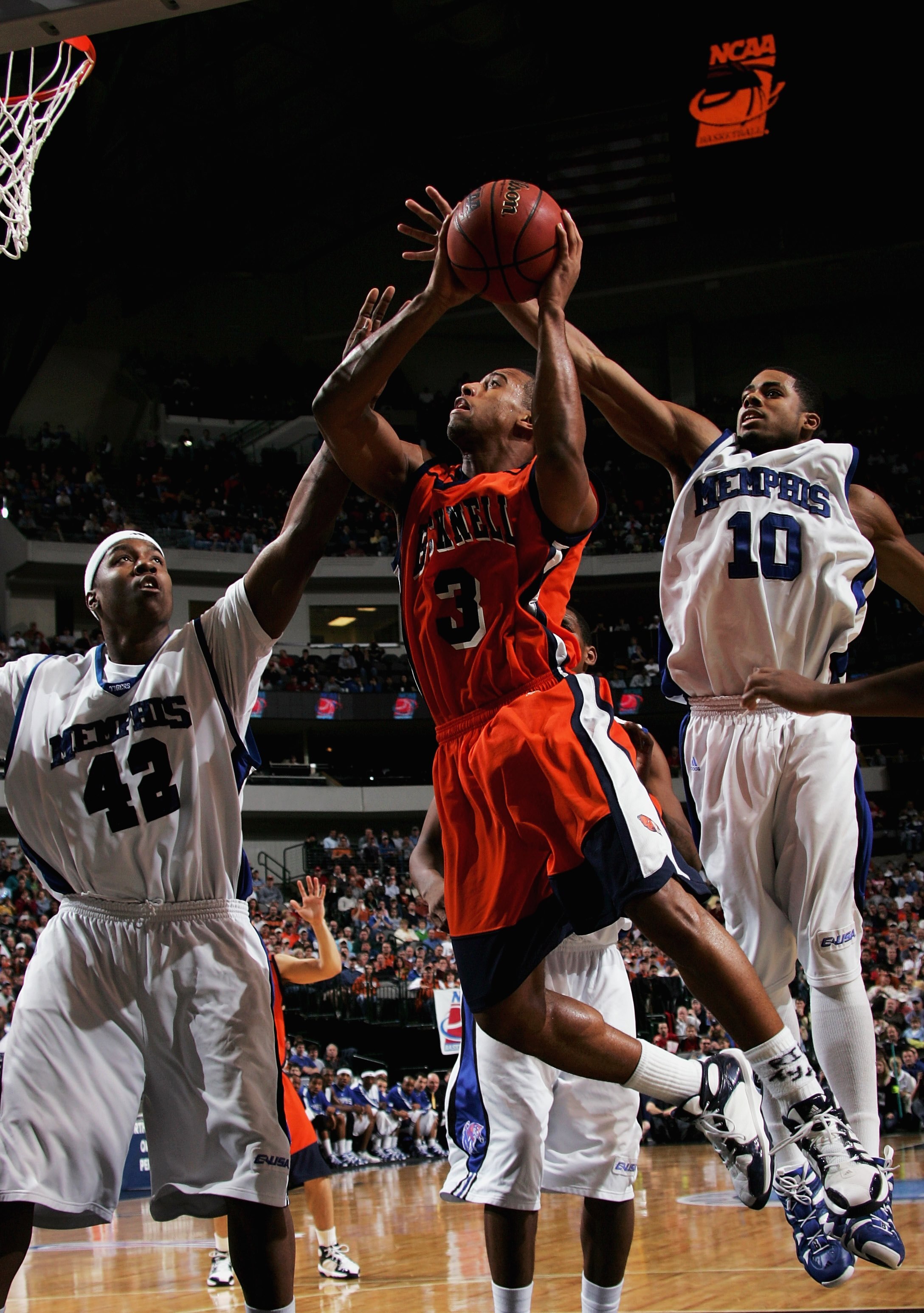 DALLAS, TEXAS - MARCH 19:  Charles Lee #3 of the Bucknell Bison goes up for a shot against Kareem Cooper #42 and Rodney Carney #10 of the Memphis Tigers during the Second Round game of the 2006 NCAA Division 1 Men's Basketball Championship Tournament on M