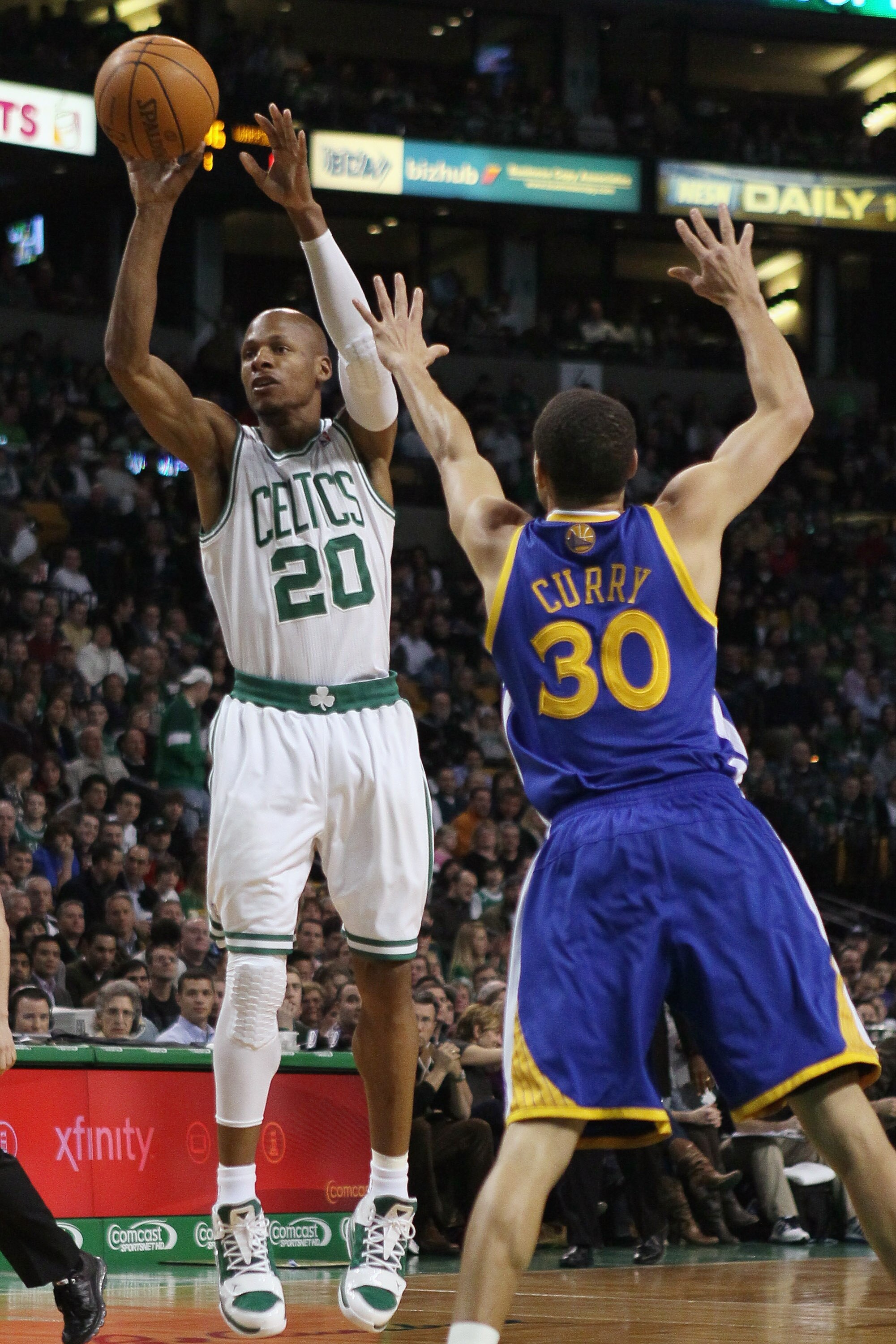 BOSTON, MA - MARCH 04:  Ray Allen #20 of the Boston Celtics takes a shot as Stephen Curry #30 of the Golden State Warriors defends on March 4, 2011 at the TD Garden in Boston, Massachusetts.  NOTE TO USER: User expressly acknowledges and agrees that, by d
