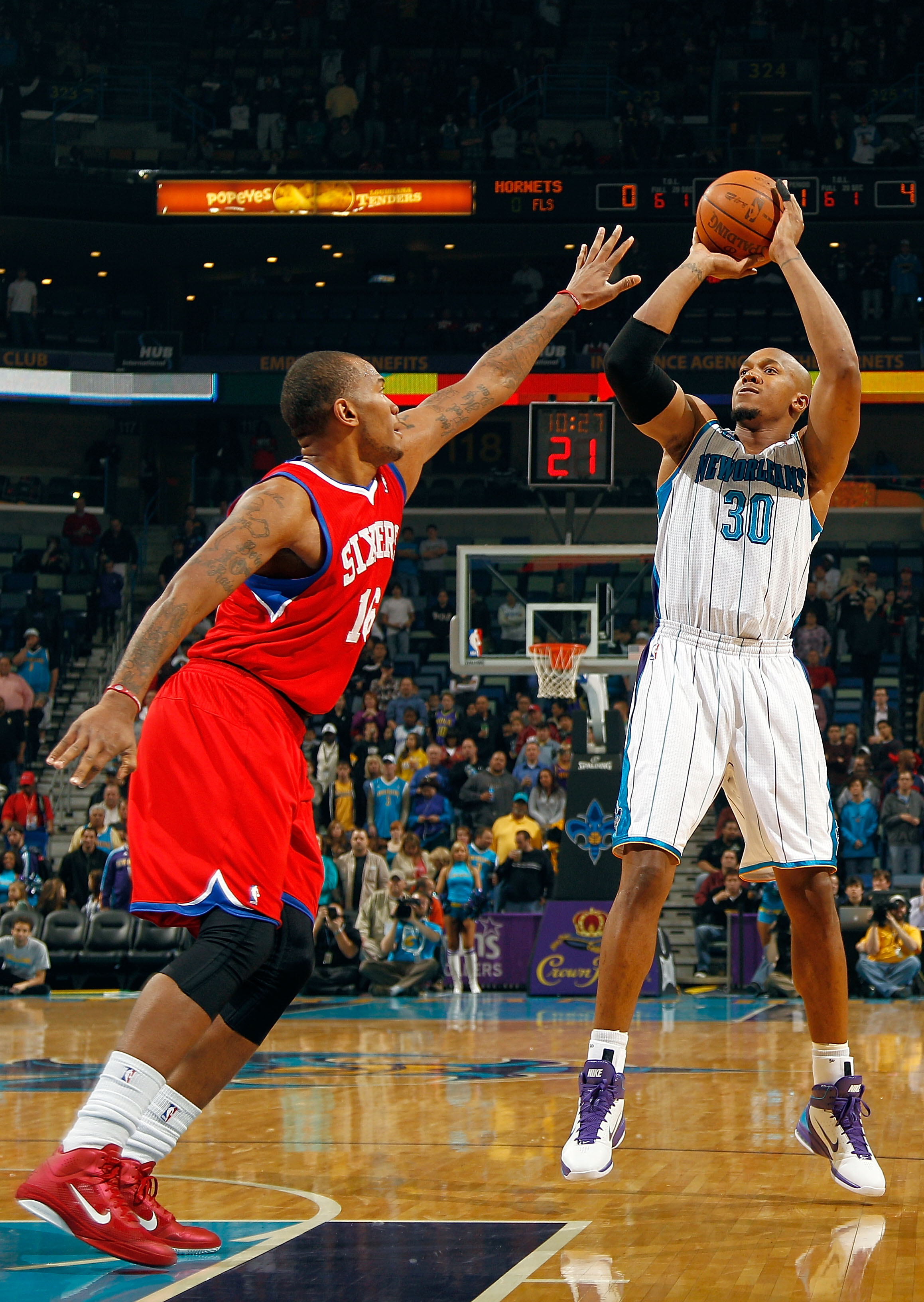 NEW ORLEANS, LA - JANUARY 03:  David West #30 of the New Orleans Hornets shoots the ball  over Marreese Speights #16 of the Philadelphia 76ers in the first half at New Orleans Arena on January 3, 2011 in New Orleans, Louisiana. NOTE TO USER: User expressl