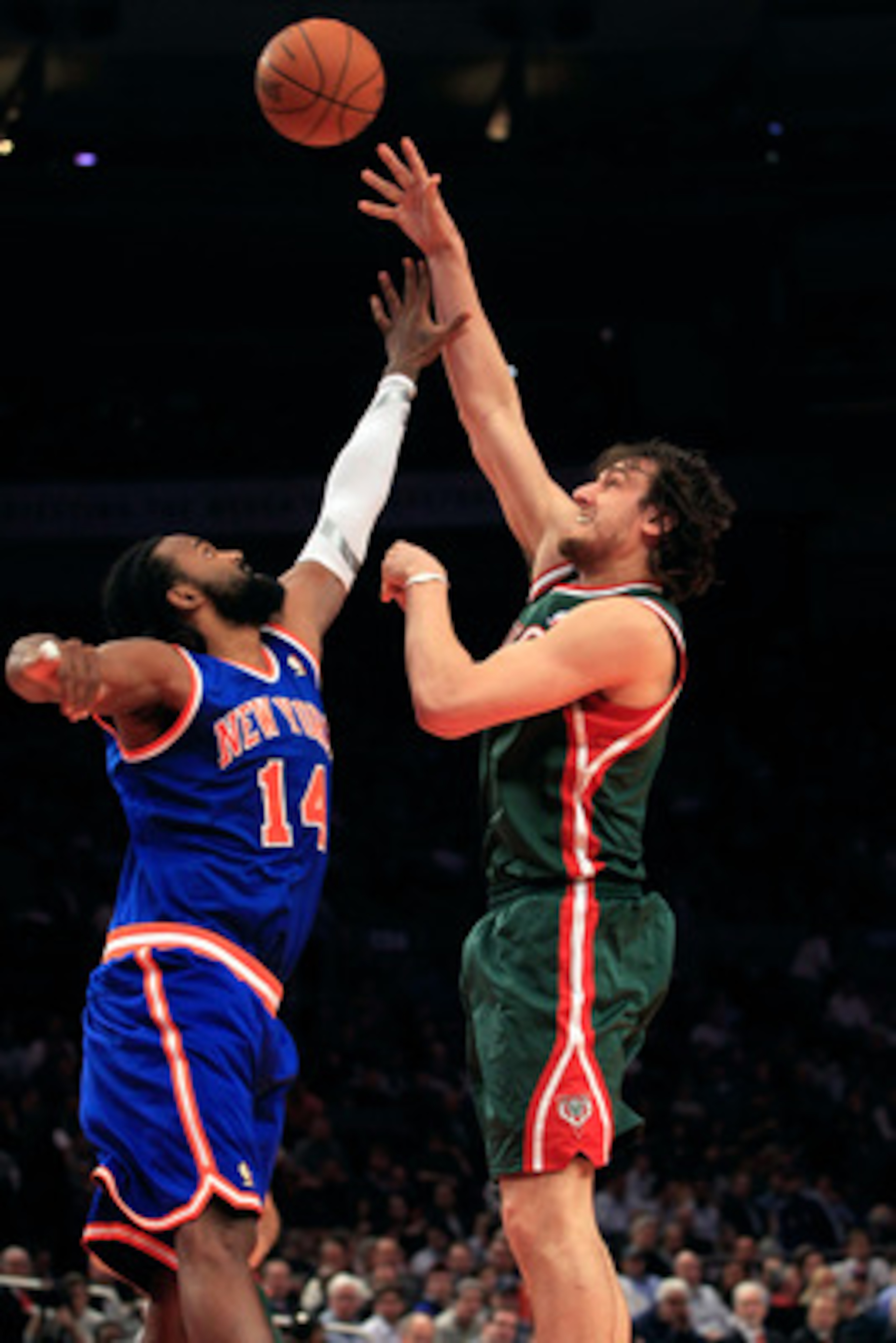 NEW YORK, NY - FEBRUARY 23:  Andrew Bogut #6 of the Milwaukee Bucks shoots the ball over Ronny Turiaf #14 of the New York Knicks at Madison Square Garden on February 23, 2011 in New York City. NOTE TO USER: User expressly acknowledges and agrees that, by