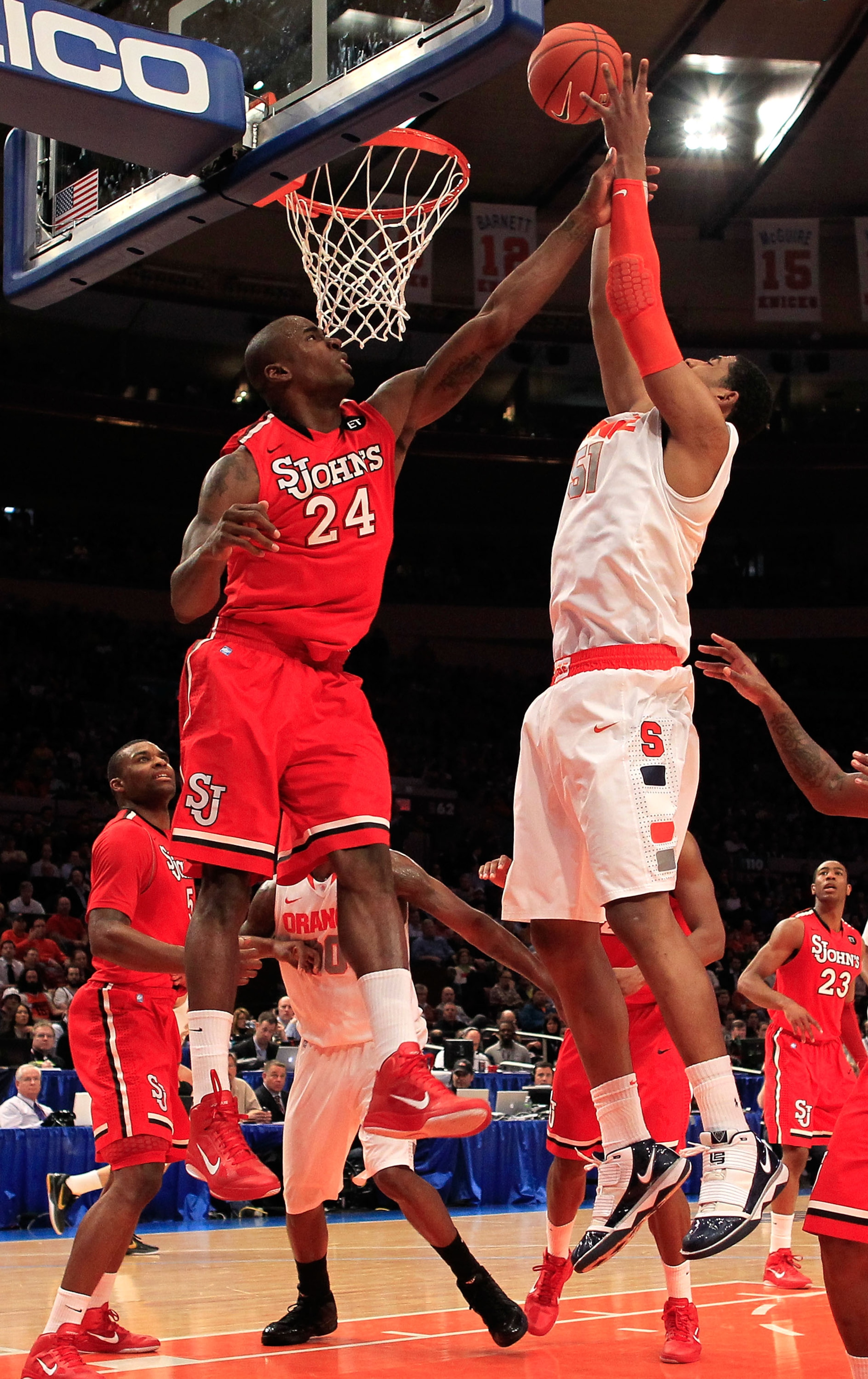 NEW YORK, NY - MARCH 10: Fab Melo #51 of the Syracuse Orange drives to the basket against Justin Burrell #24 of the St. John's Red Storm during the quarterfinals of the 2011 Big East Men's Basketball Tournament presented by American Eagle Outfitters  at M