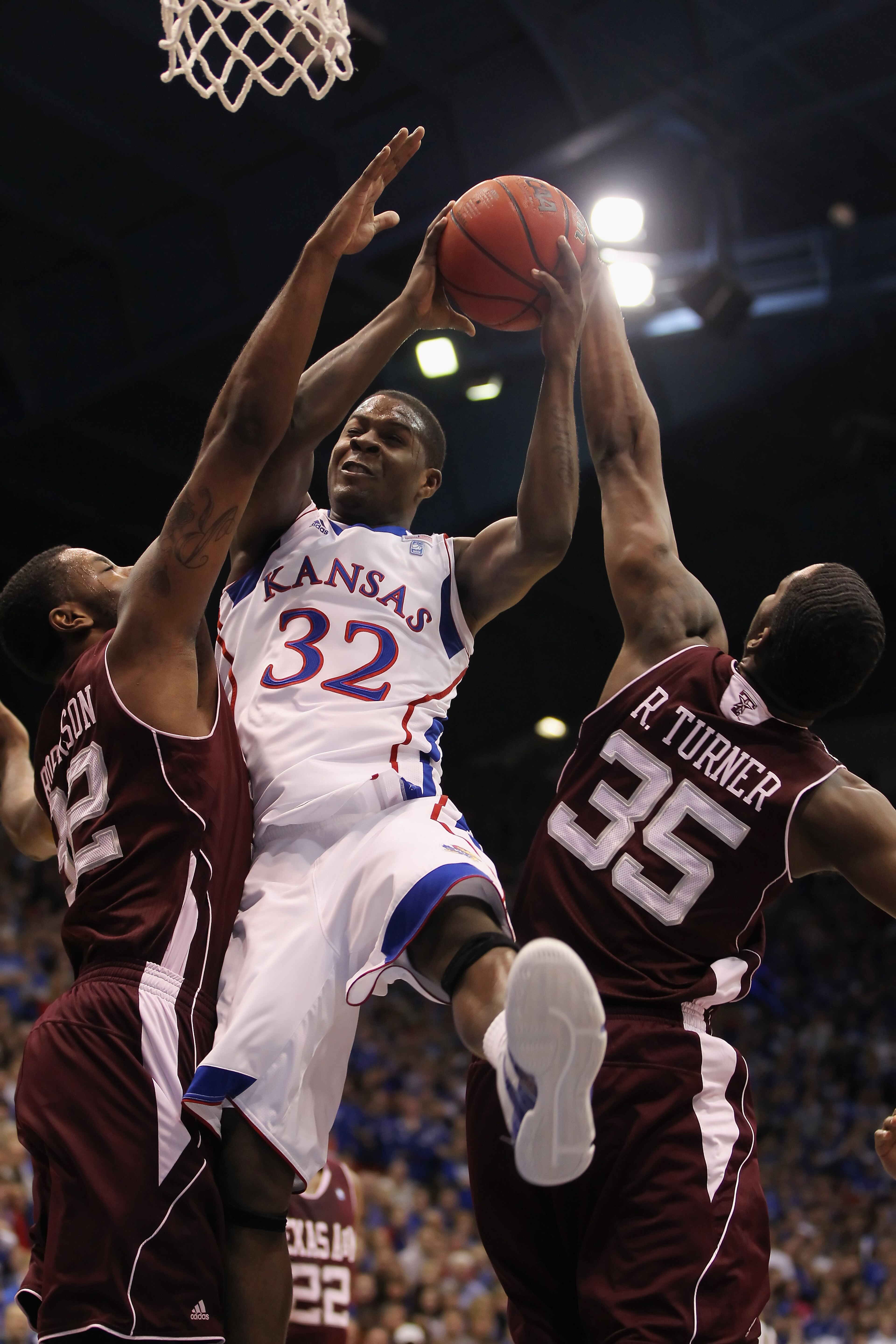 LAWRENCE, KS - MARCH 02:  Josh Selby #32 of the Kansas Jayhawks shoots as Ray Turner #35 the Texas A&M Aggies blocks during the game on March 2, 2011 at Allen Fieldhouse in Lawrence, Kansas.  (Photo by Jamie Squire/Getty Images)