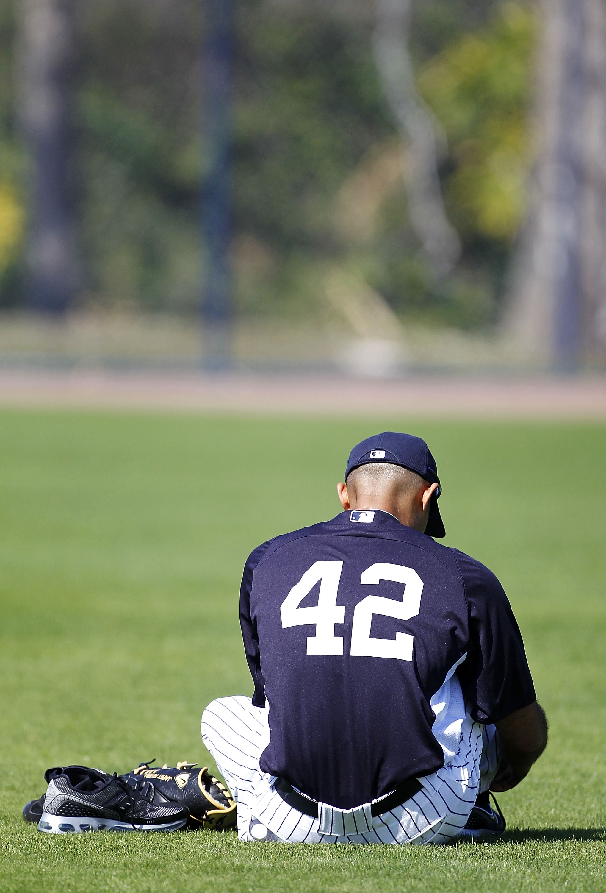 TAMPA, FL - FEBRUARY 21: Mariano Rivera #42 of the New York Yankees takes time out to change his shoes during the second day of full teams workouts at Spring Training on February 21, 2011 at the George M. Steinbrenner Field in Tampa, Florida. (Photo by L TAMPA, FL - FEBRUARY 21: Mariano Rivera #42 of the New York Yankees takes time out to change his shoes during the second day of full teams workouts at Spring Training on February 21, 2011 at the George M. Steinbrenner Field in Tampa, Florida. (Photo by L
