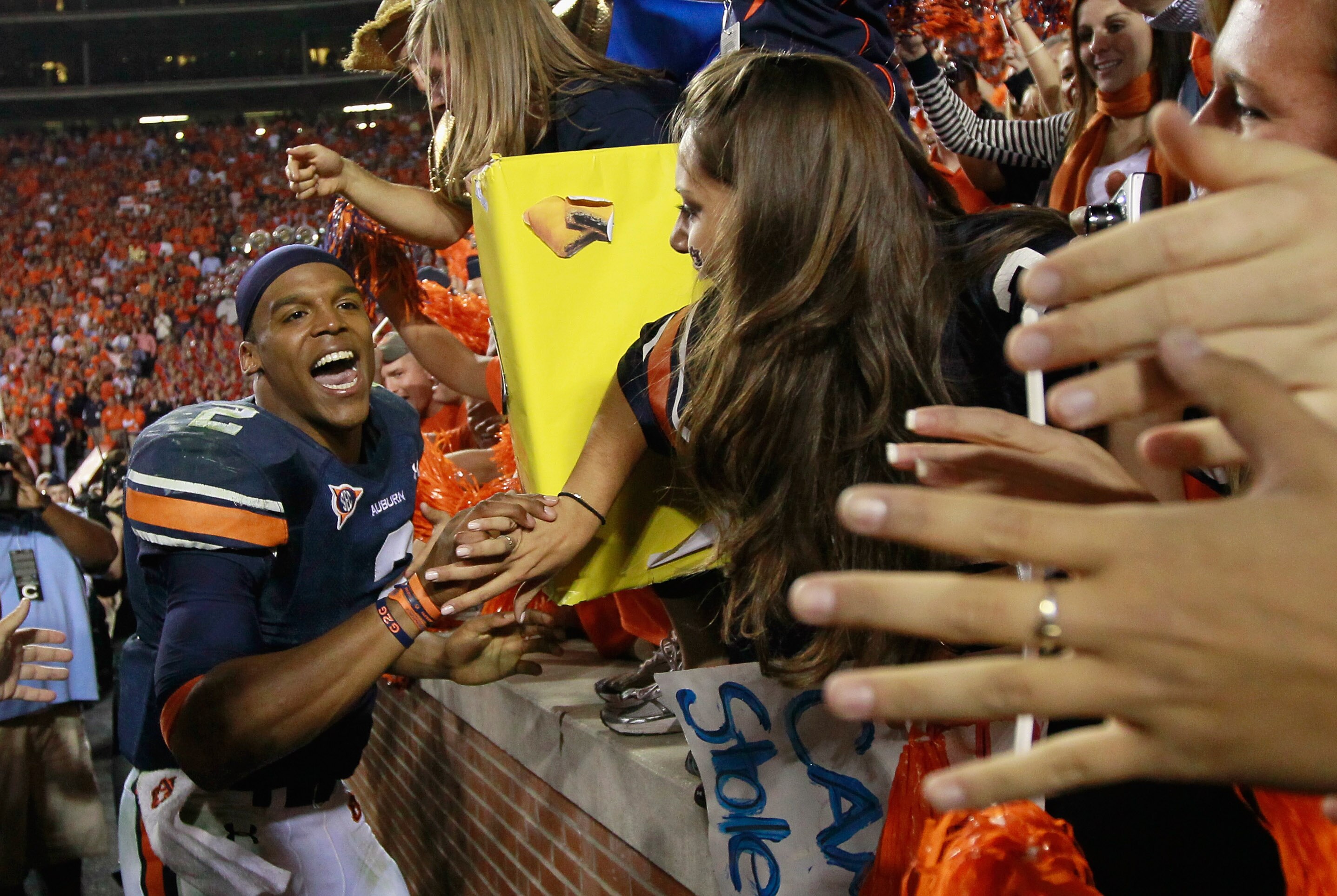AUBURN, AL - NOVEMBER 13:  Quarterback Cameron Newton #2 of the Auburn Tigers celebrates with fans after their 49-31 win over the Georgia Bulldogs at Jordan-Hare Stadium on November 13, 2010 in Auburn, Alabama.  (Photo by Kevin C. Cox/Getty Images)