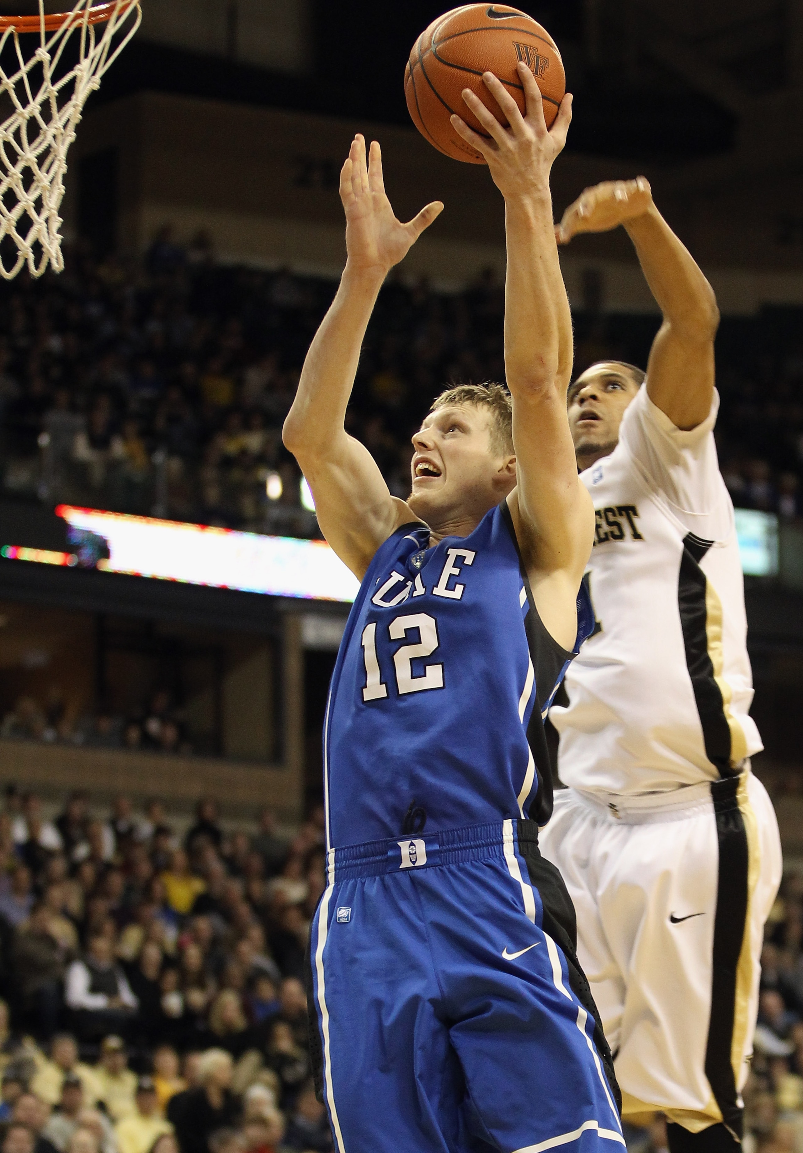 WINSTON SALEM, NC - JANUARY 22: Kyle Singler #12 of the Duke Blue Devils drives to the basket against Ty Walker #40 of the Wake Forest Demon Deacons at Lawrence Joel Coliseum on January 22, 2011 in Winston Salem, North Carolina. (Photo by Streeter Lecka WINSTON SALEM, NC - JANUARY 22: Kyle Singler #12 of the Duke Blue Devils drives to the basket against Ty Walker #40 of the Wake Forest Demon Deacons at Lawrence Joel Coliseum on January 22, 2011 in Winston Salem, North Carolina. (Photo by Streeter Lecka