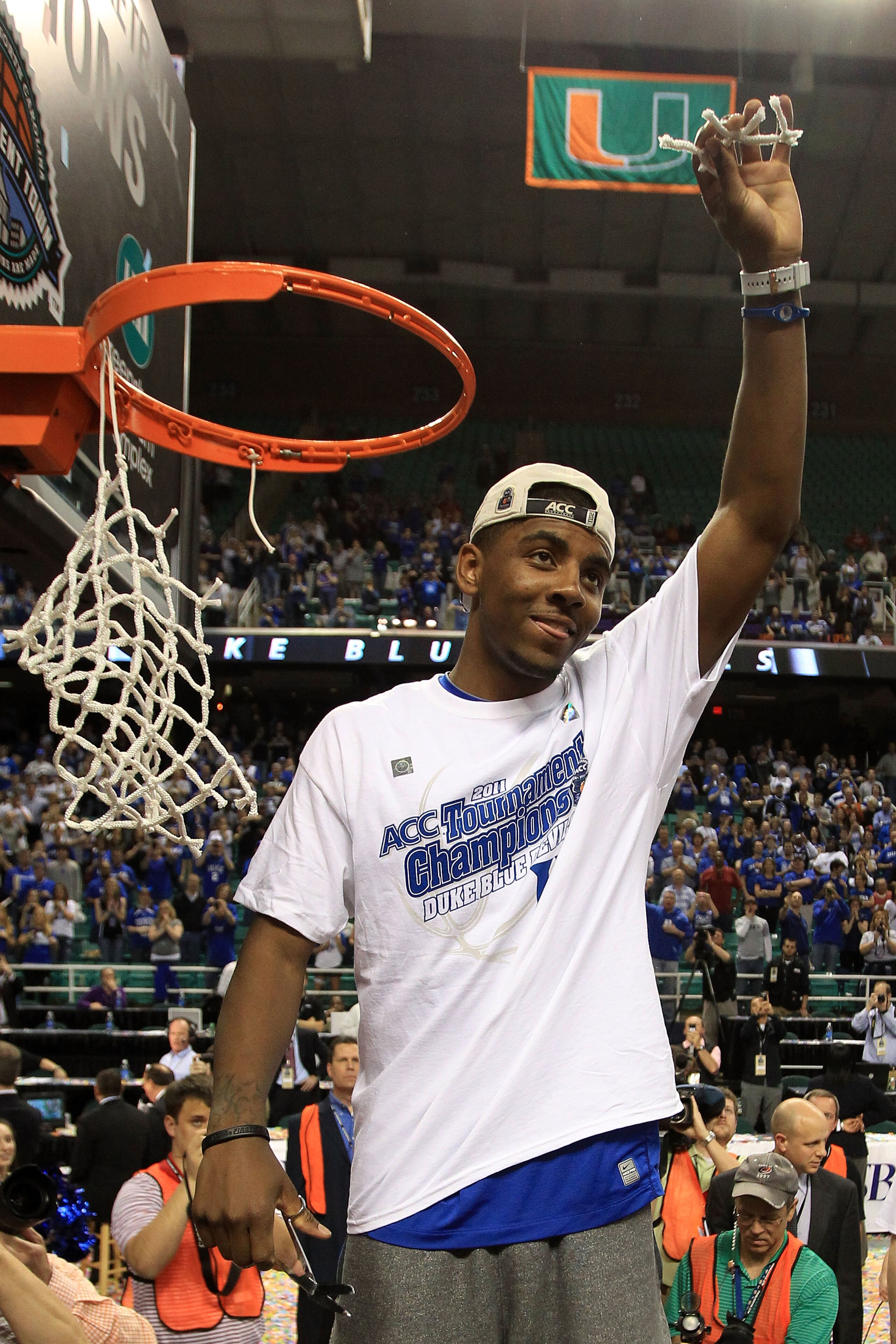 GREENSBORO, NC - MARCH 13:  Kyrie Irving #1 of the Duke Blue Devils cuts down the net after defeating the North Carolina Tar Heels 75-58 in the championship game of the 2011 ACC men's basketball tournament at the Greensboro Coliseum on March 13, 2011 in G