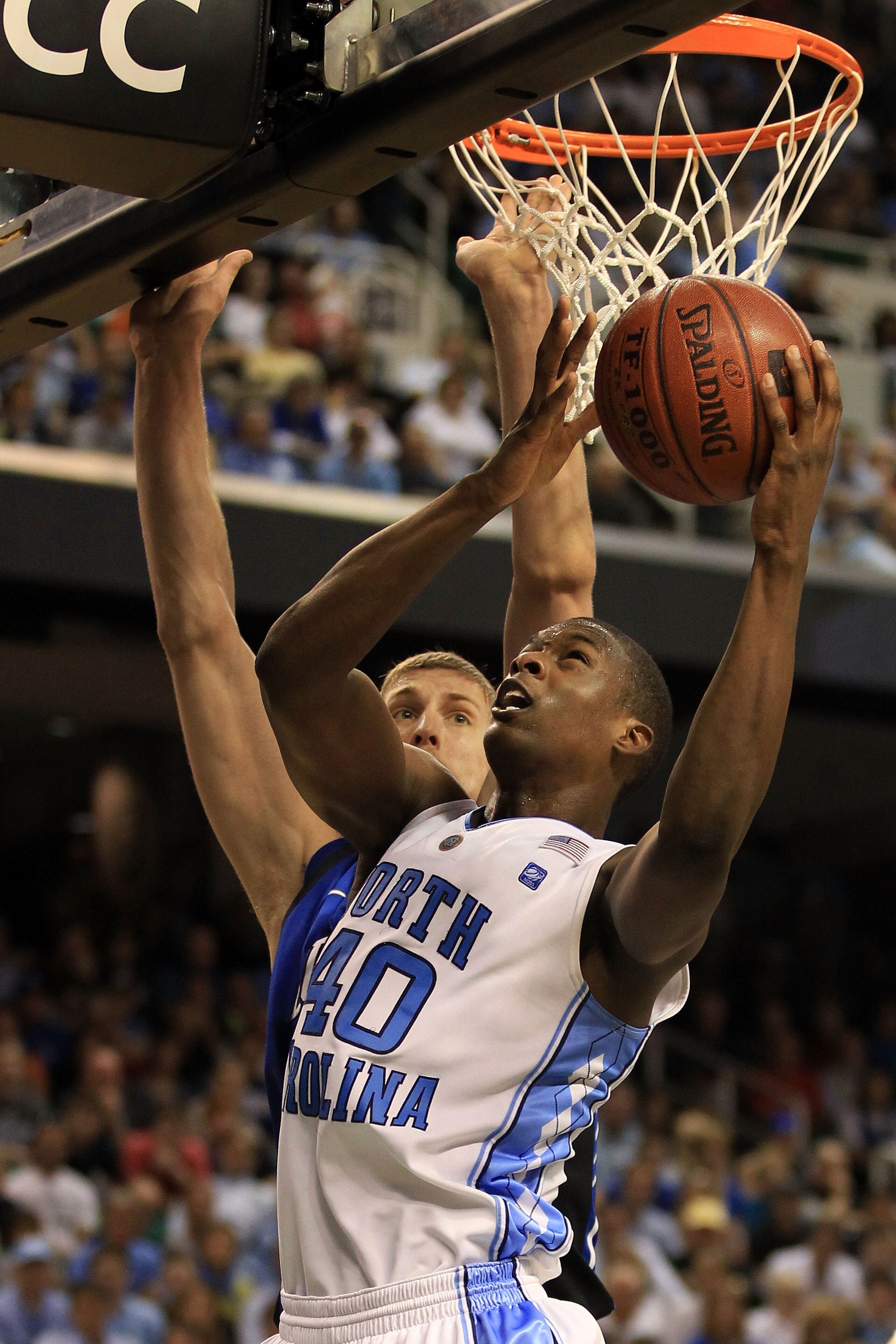 GREENSBORO, NC - MARCH 13: Harrison Barnes #40 of the North Carolina Tar Heels shoots against Mason Plumlee #5 of the Duke Blue Devils during the second half in the championship game of the 2011 ACC men's basketball tournament at the Greensboro Coliseum GREENSBORO, NC - MARCH 13: Harrison Barnes #40 of the North Carolina Tar Heels shoots against Mason Plumlee #5 of the Duke Blue Devils during the second half in the championship game of the 2011 ACC men's basketball tournament at the Greensboro Coliseum