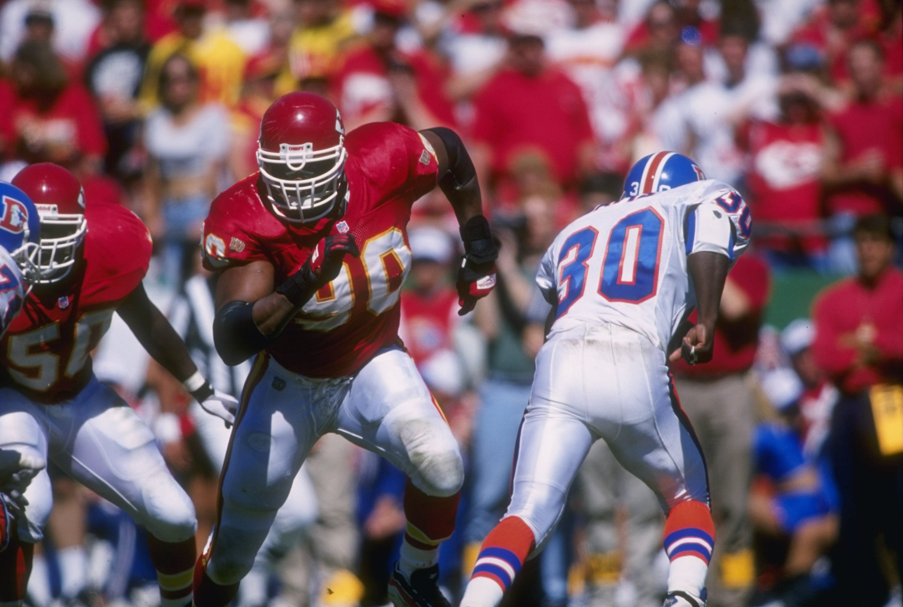 22 Sep 1996: Defensive end Neil Smith #90 of the Kansas City Chiefs stares into the back field as he pursues the ball carrier for a tackle during a play in the Chiefs 17-14 victory over the Broncos at Arrowhead Stadium in Kansas City, Missouri.