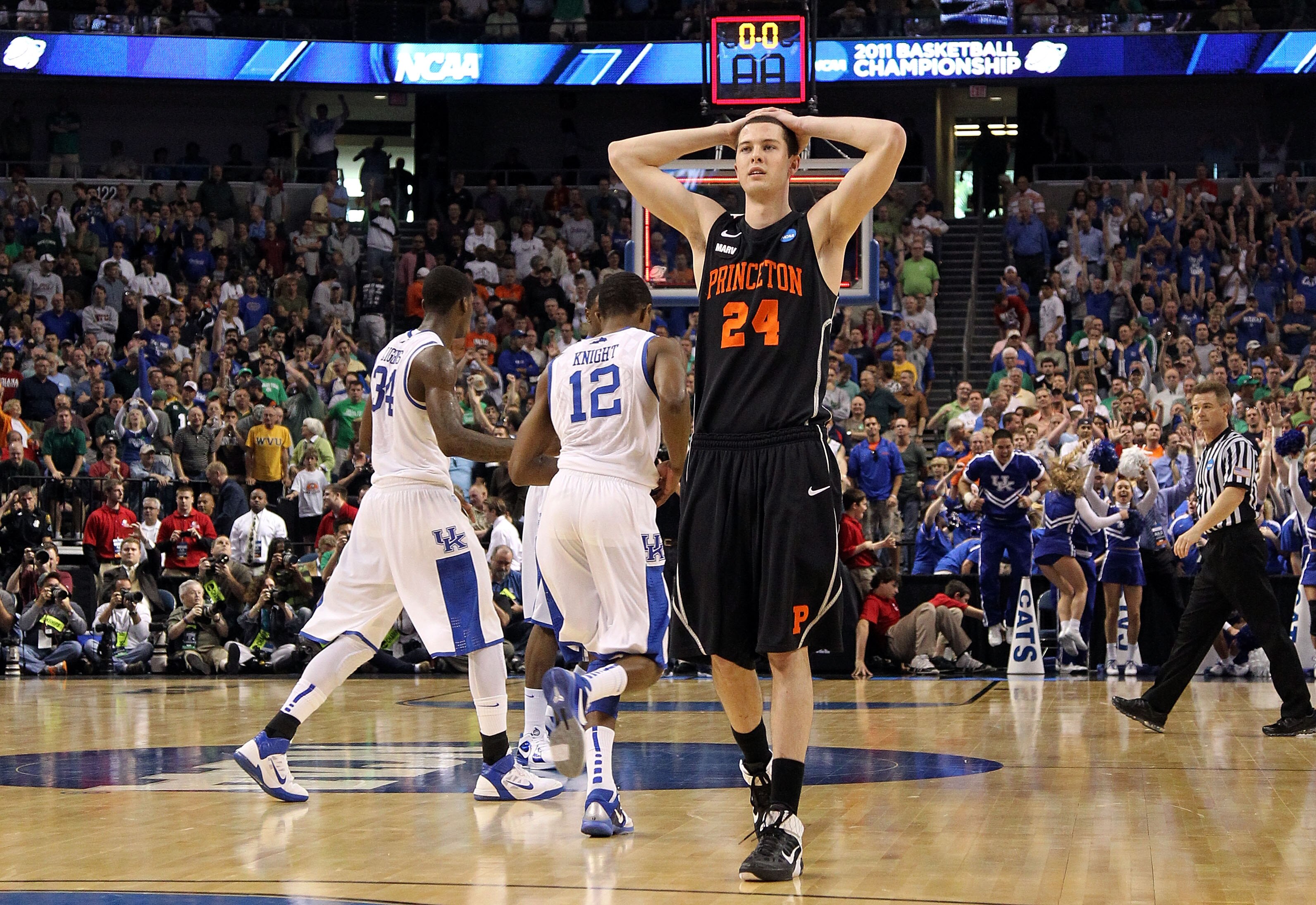 TAMPA, FL - MARCH 17: Will Barrett #24 of the Princeton Tigers looks on dejected as Brandon Knight #12 and DeAndre Liggins #34 of the Kentucky Wildcats celebrate their 59-57 win during the second round of the 2011 NCAA men's basketball tournament at St. TAMPA, FL - MARCH 17: Will Barrett #24 of the Princeton Tigers looks on dejected as Brandon Knight #12 and DeAndre Liggins #34 of the Kentucky Wildcats celebrate their 59-57 win during the second round of the 2011 NCAA men's basketball tournament at St.