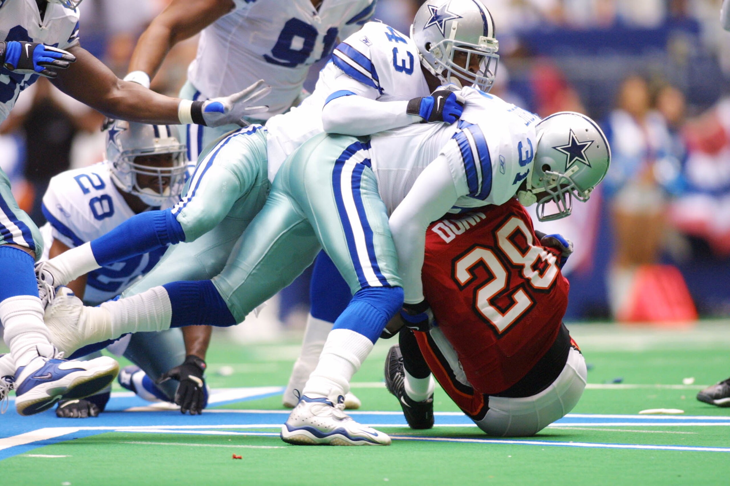 9 Sep 2001:  Warrick Dunn #28 of the Tampa Bay Buccaneers is tackled by George Teague #31 and Izell Reese #43 of the Dallas Cowboys at Texas Stadium in Irving, Texas.  Tampa Bay won 10-6.  DIGITAL IMAGE  Mandatory Credit:  Ronald Martinez/Allsport