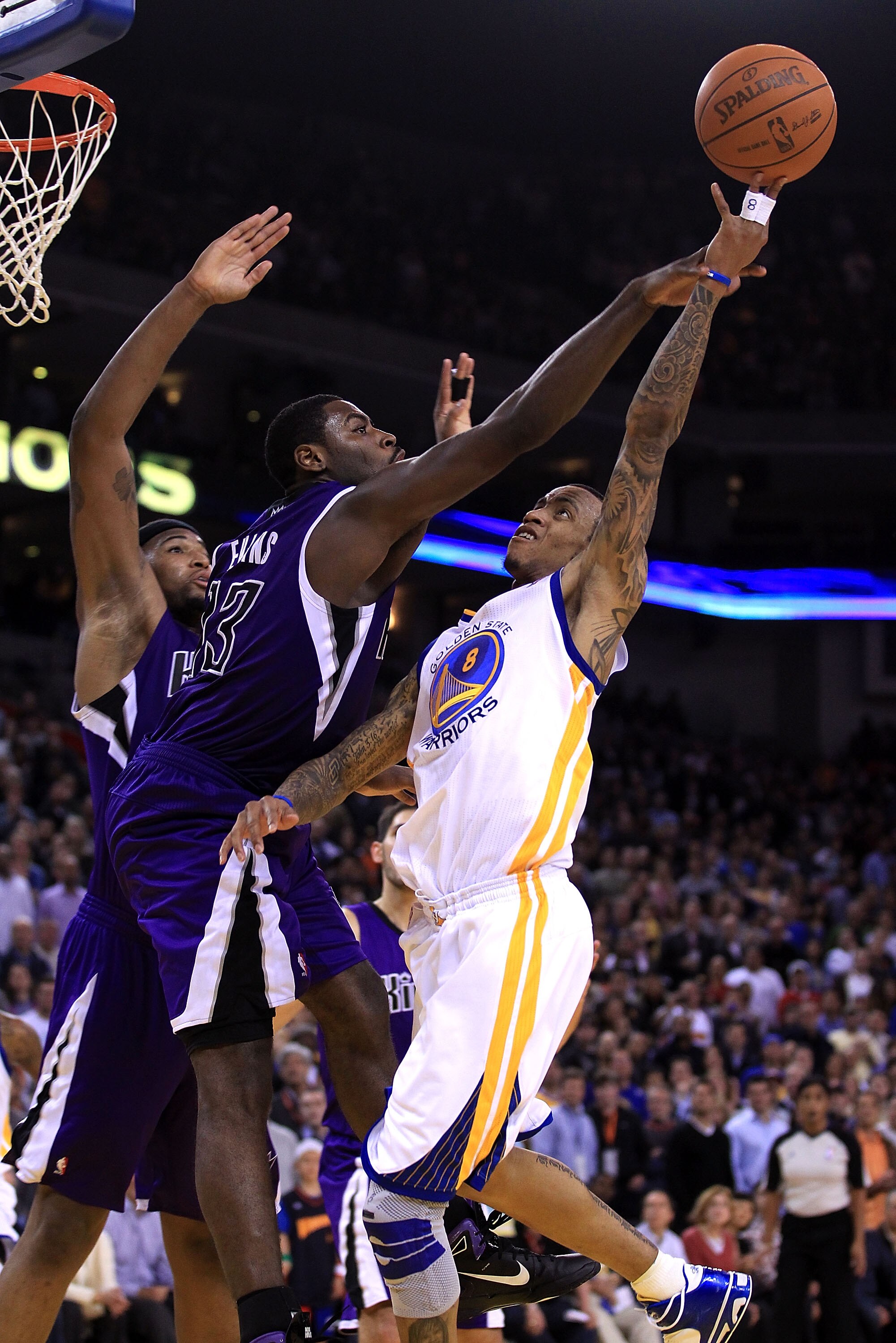 OAKLAND, CA - JANUARY 21:  Monta Ellis #8 of the Golden State Warriors shoots over Tyreke Evans #13 of the Sacramento Kings at Oracle Arena on January 21, 2011 in Oakland, California. NOTE TO USER: User expressly acknowledges and agrees that, by downloadi