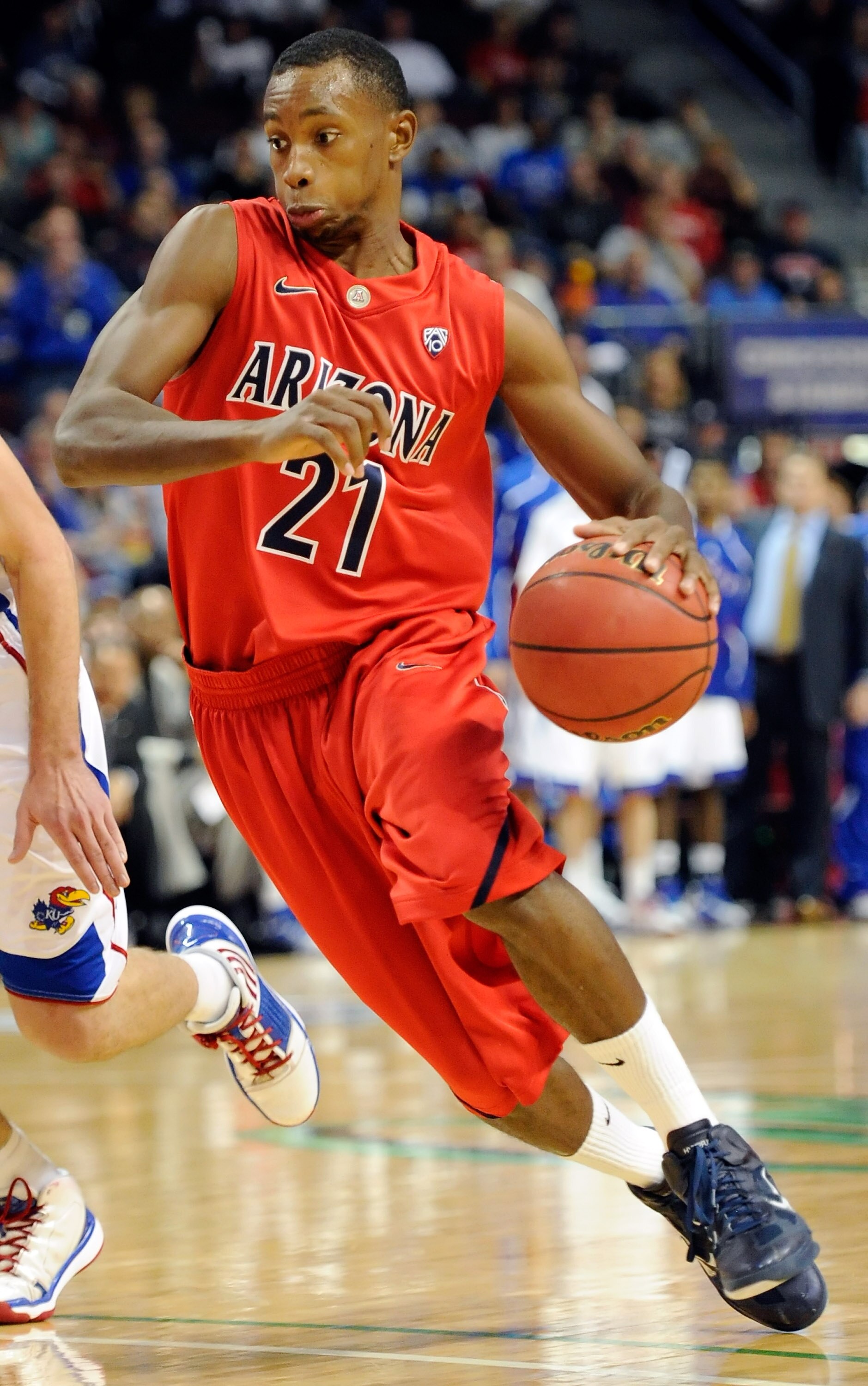 LAS VEGAS - NOVEMBER 27:  Kyle Fogg #21 of the Arizona Wildcats drives against the Kansas Jayhawks during the championship game of the Las Vegas Invitational at The Orleans Arena November 27, 2010 in Las Vegas, Nevada. Kansas won 87-79.  (Photo by Ethan M