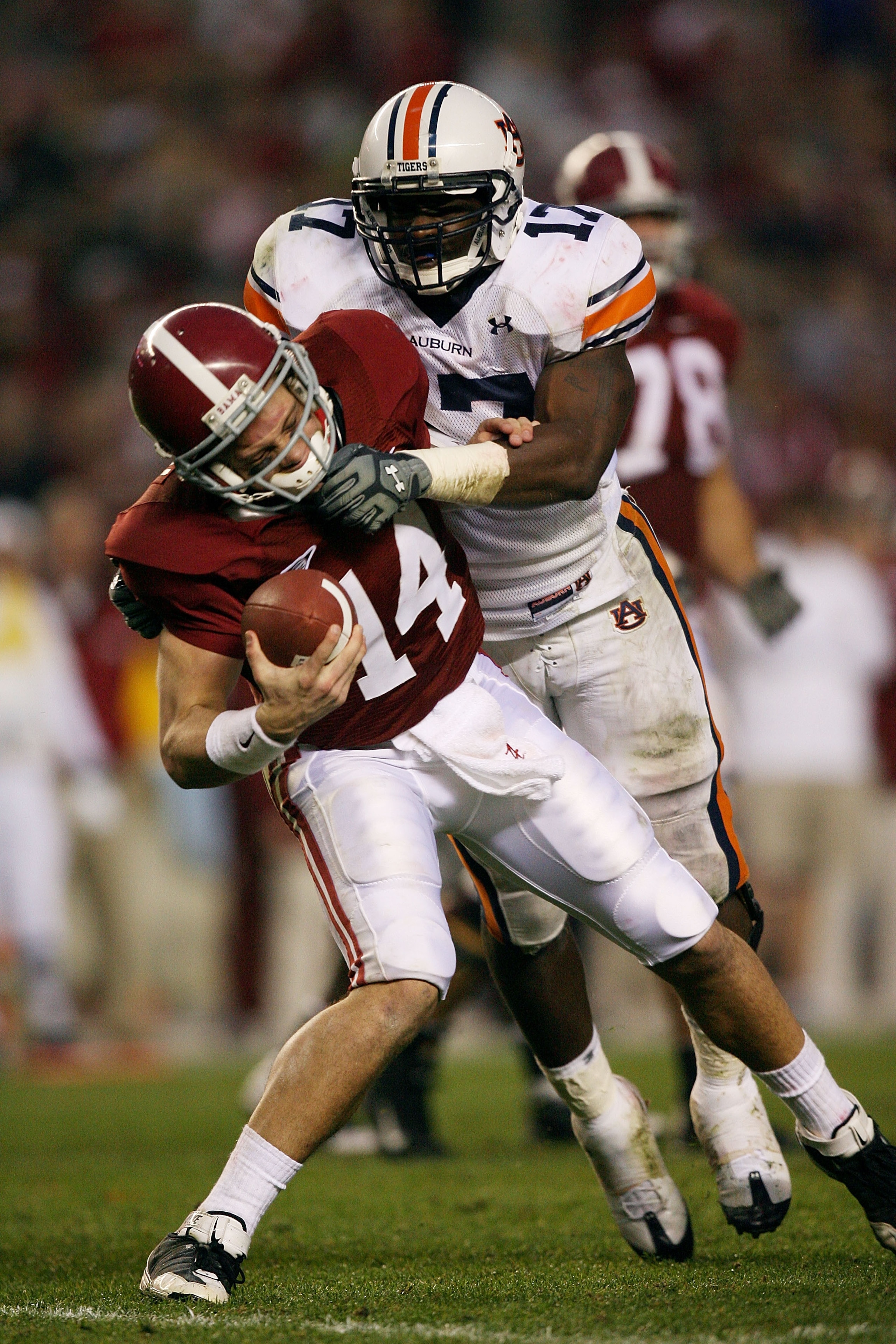 TUSCALOOSA, AL - NOVEMBER 29: Quarterback John Parker Wilson #14 of the Alabama Crimson Tide escapes a sack attempt by linebacker Josh Bynes #17 of the Auburn Tigers at Bryant-Denny Stadium on November 29, 2008 in Tuscaloosa, Alabama. Alabama defeated A TUSCALOOSA, AL - NOVEMBER 29: Quarterback John Parker Wilson #14 of the Alabama Crimson Tide escapes a sack attempt by linebacker Josh Bynes #17 of the Auburn Tigers at Bryant-Denny Stadium on November 29, 2008 in Tuscaloosa, Alabama. Alabama defeated A
