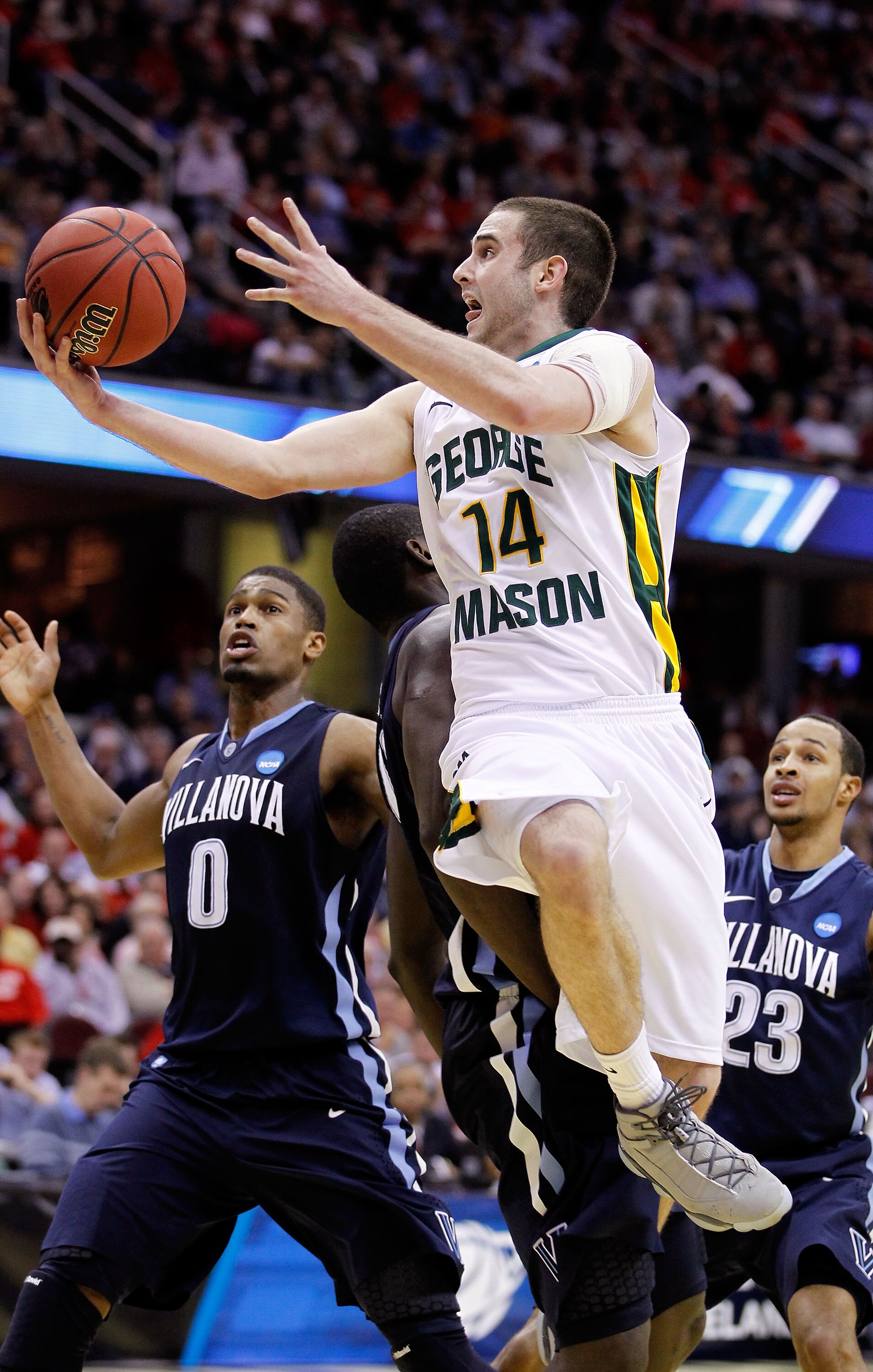 CLEVELAND, OH - MARCH 18: Luke Hancock #14 of the George Mason Patriots drives to the basket against Mouphtaou Yarou #13 of the Villanova Wildcats during the second round of the 2011 NCAA men's basketball tournament at Quicken Loans Arena on March 18, 201