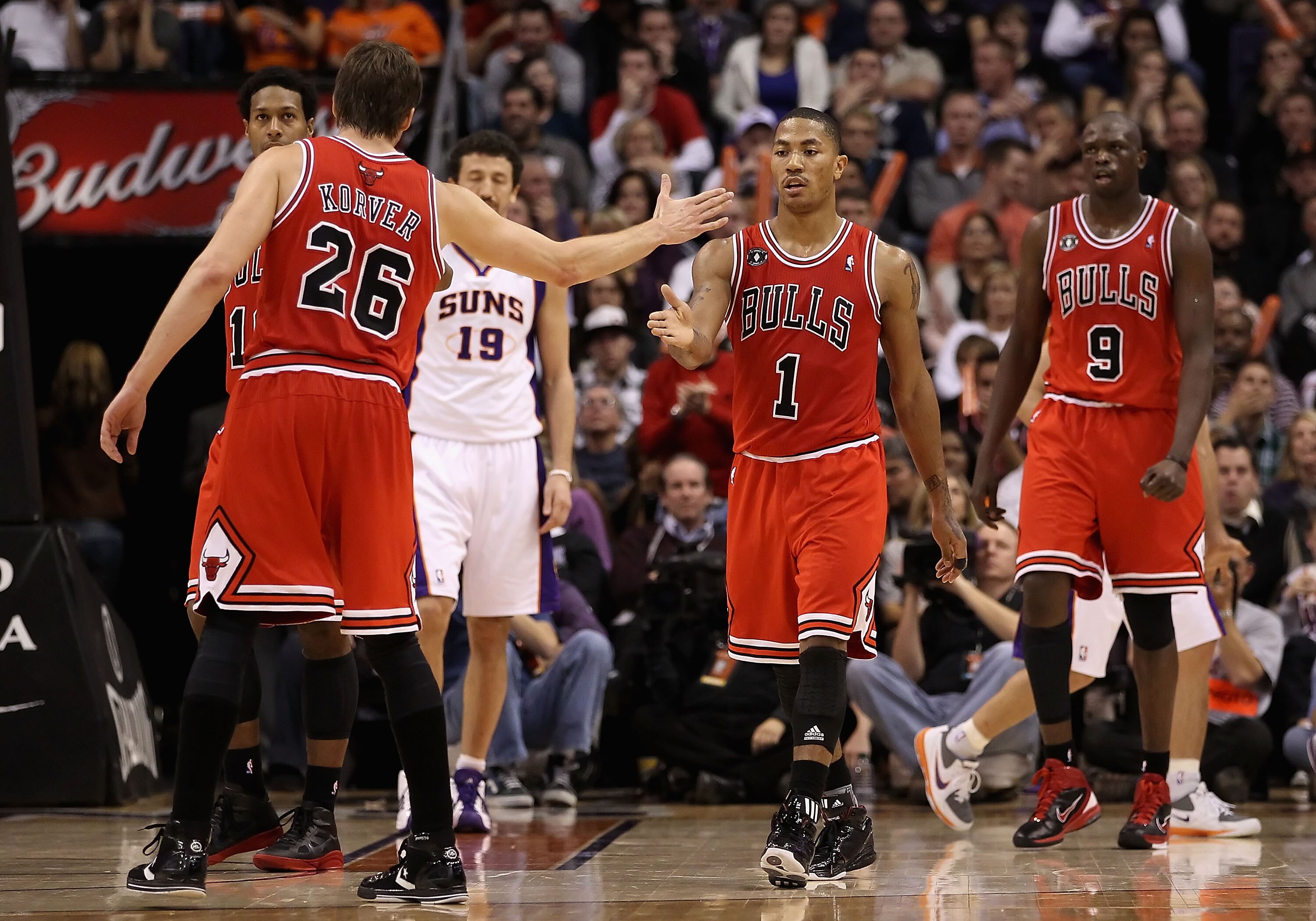 PHOENIX - NOVEMBER 24:  Derrick Rose #1 of the Chicago Bulls high fives teammate  Kyle Korver #26 after scoring against the Phoenix Suns during the NBA game at US Airways Center on November 24, 2010 in Phoenix, Arizona. The Bulls defeated the Suns 123-115