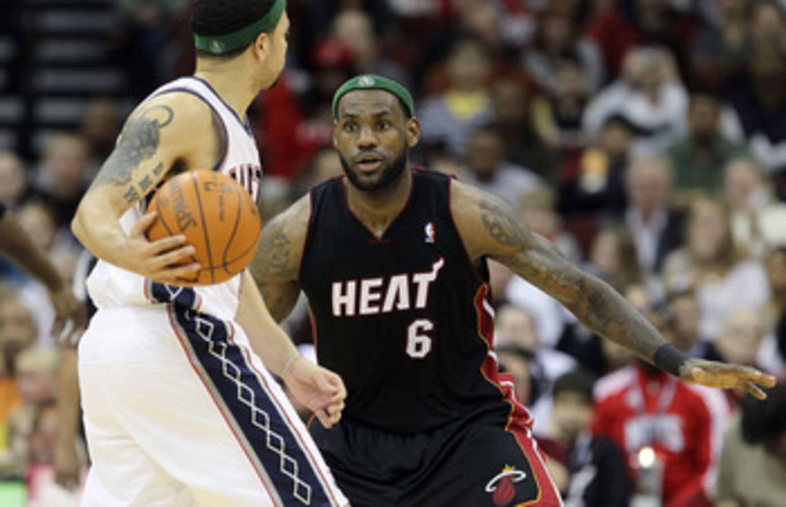 NEWARK, NJ - APRIL 03:  LeBron James #6 of the Miami Heat defends against Deron Williams #8 of the New Jersey Nets at the Prudential Center on April 3, 2011 in Newark, New Jersey.The Heat defeated the Nets 108-94.NOTE TO USER: User expressly acknowledges