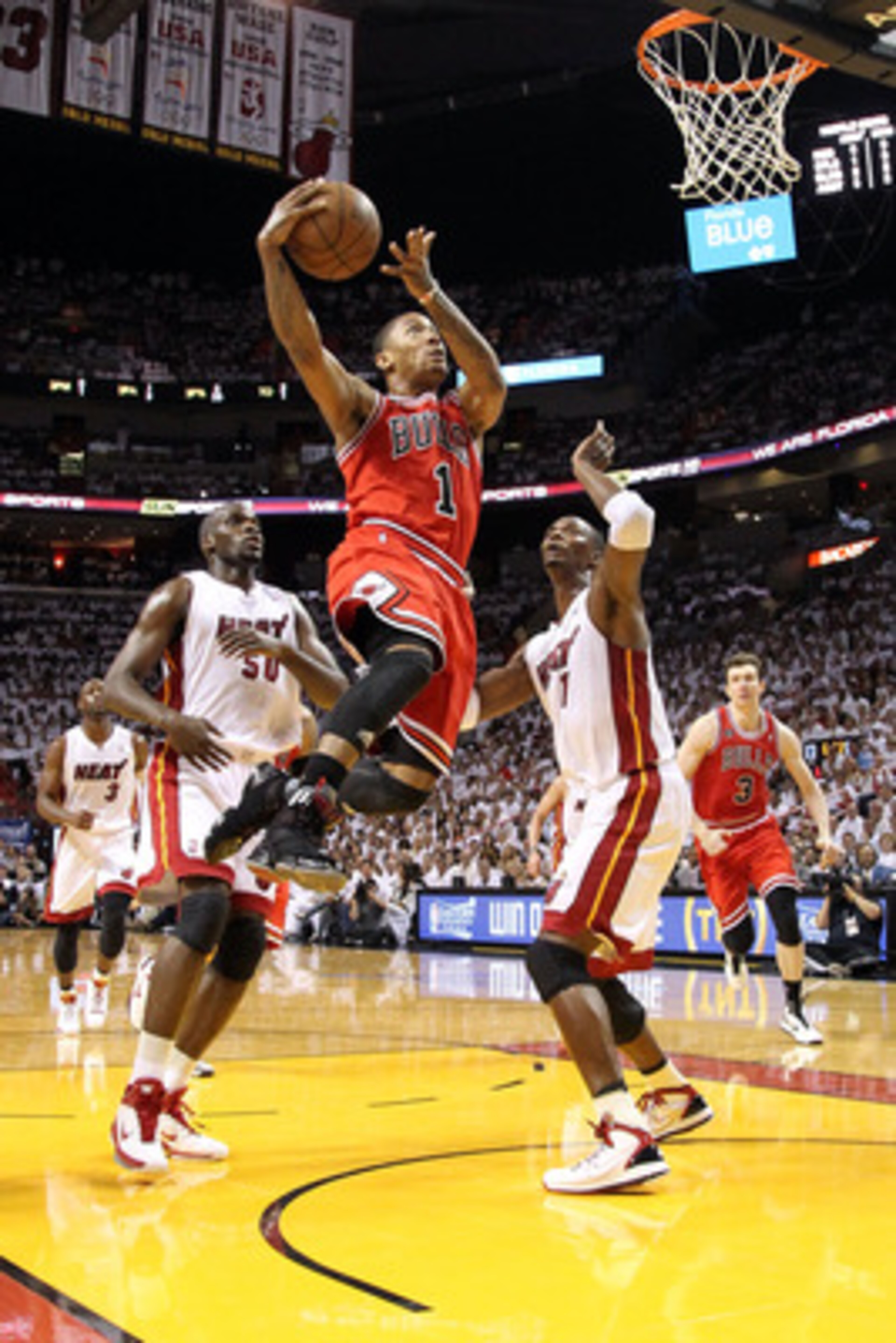 MIAMI, FL - MAY 22:  Derrick Rose #1 of the Chicago Bulls drivers for a shot attempt against Chris Bosh #1 and Joel Anthony #50 of the Miami Heat in Game Three of the Eastern Conference Finals during the 2011 NBA Playoffs on May 22, 2011 at American Airli