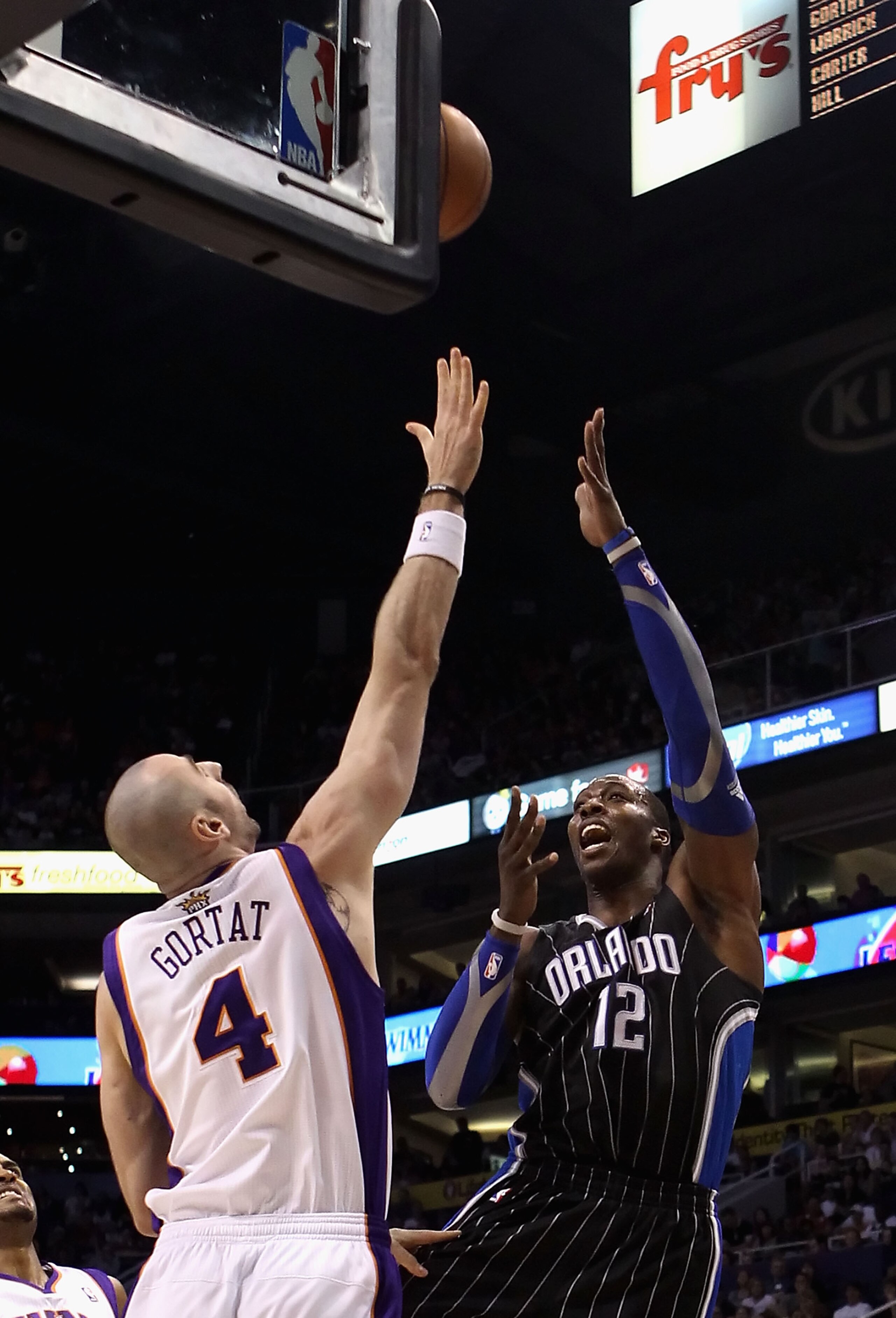 PHOENIX, AZ - MARCH 13:  Dwight Howard #12 of the Orlando Magic puts up a shot during the NBA game against the Phoenix Suns at US Airways Center on March 13, 2011 in Phoenix, Arizona. The Magic defeated the Suns 111-88. NOTE TO USER: User expressly acknow