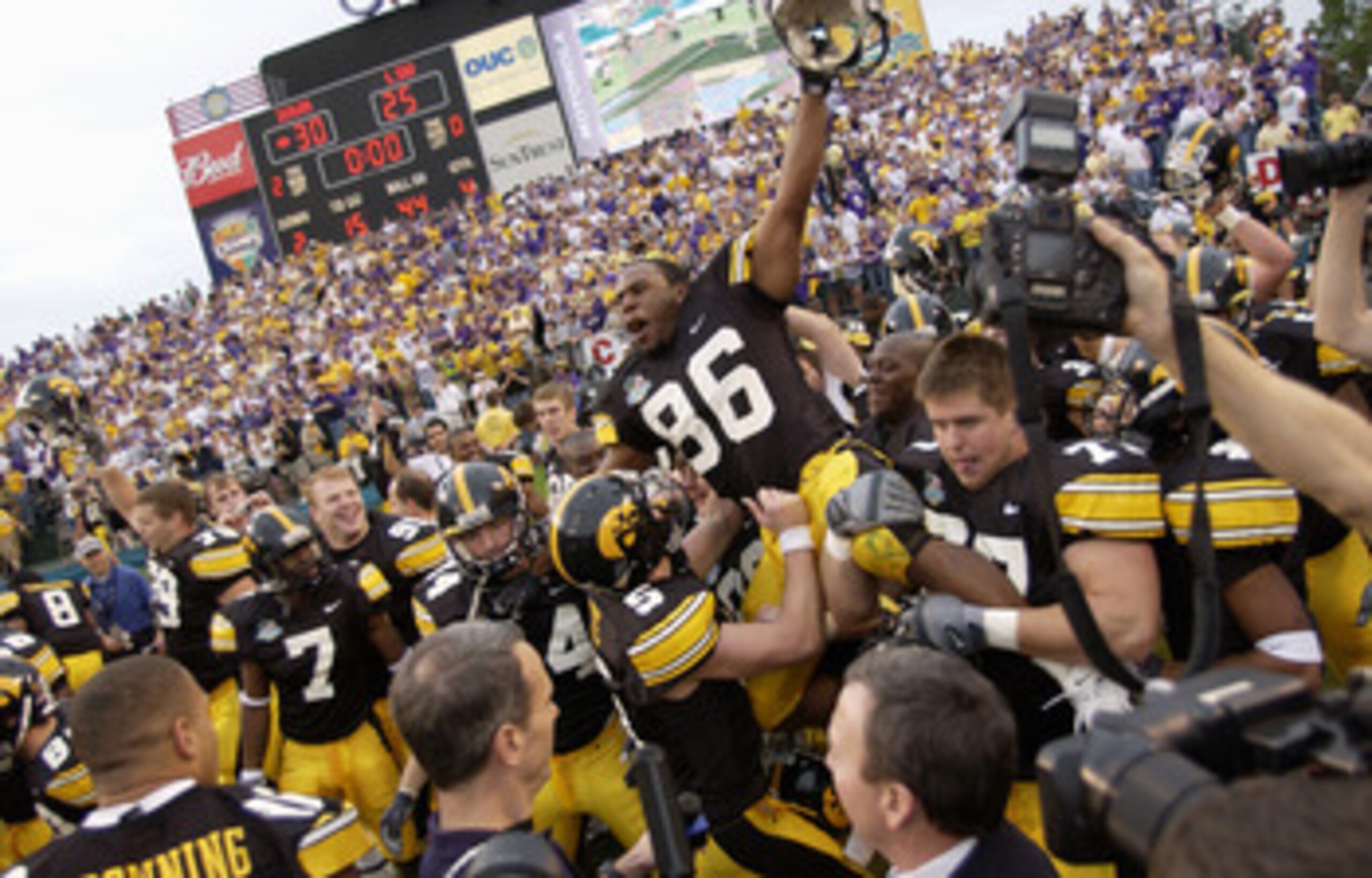 ORLANDO, FL - JANUARY 1:  Warren Holloway #86 of the Iowa Hawkeyes is carried on the field by teammates following the Capital One Bowl game against the LSU Tigers at the Florida Citrus Bowl on January 1, 2005 in Orlando, Florida. The Hawkeyes won 30-25. (