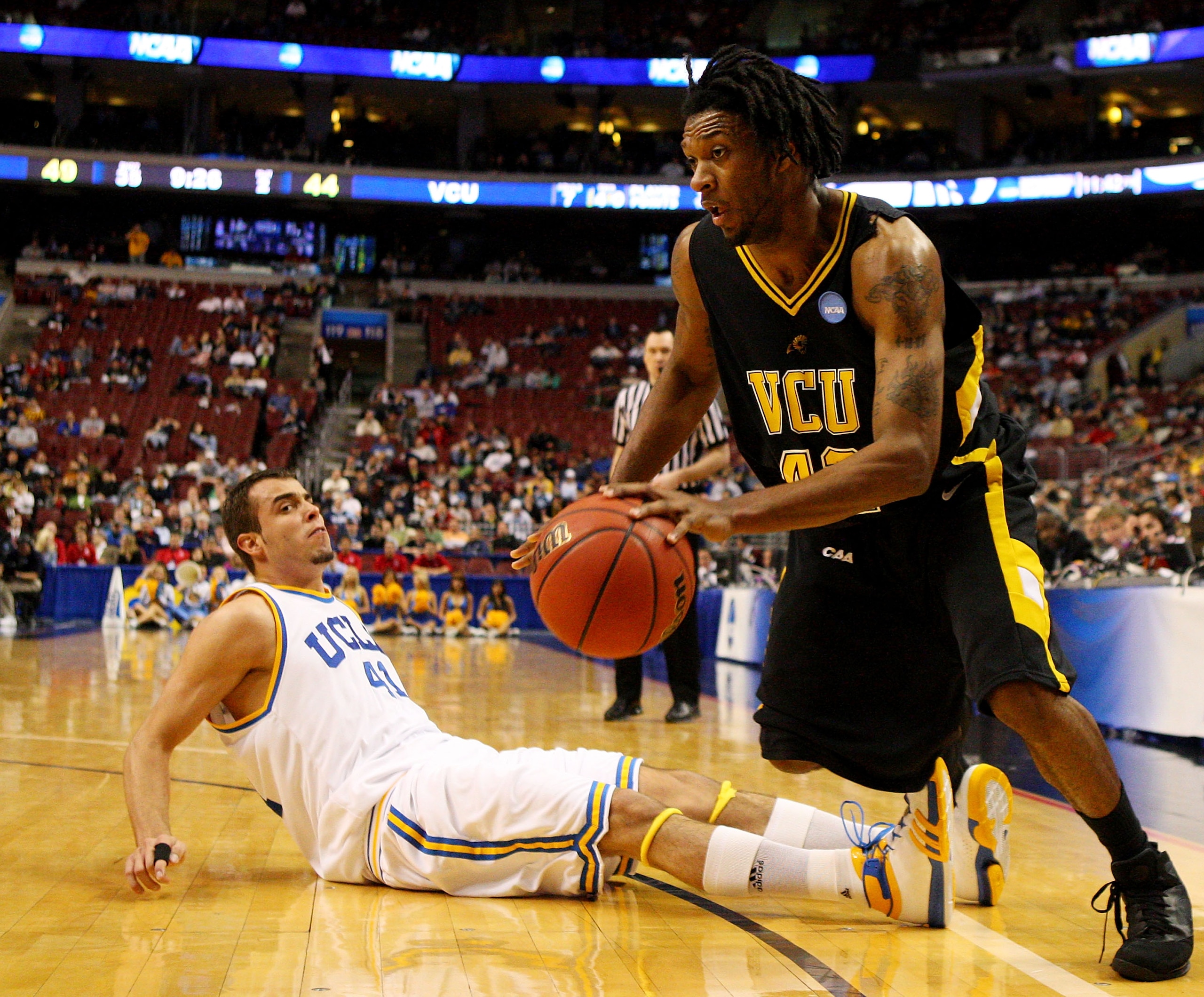 PHILADELPHIA - MARCH 19:  T.J. Gwynn #42 of the VCU Rams drives past Nikola Dragovic #41 of the UCLA Bruins during the first round of the NCAA Division I Men's Basketball Tournament at the Wachovia Center on March 19, 2009 in Philadelphia, Pennsylvania.