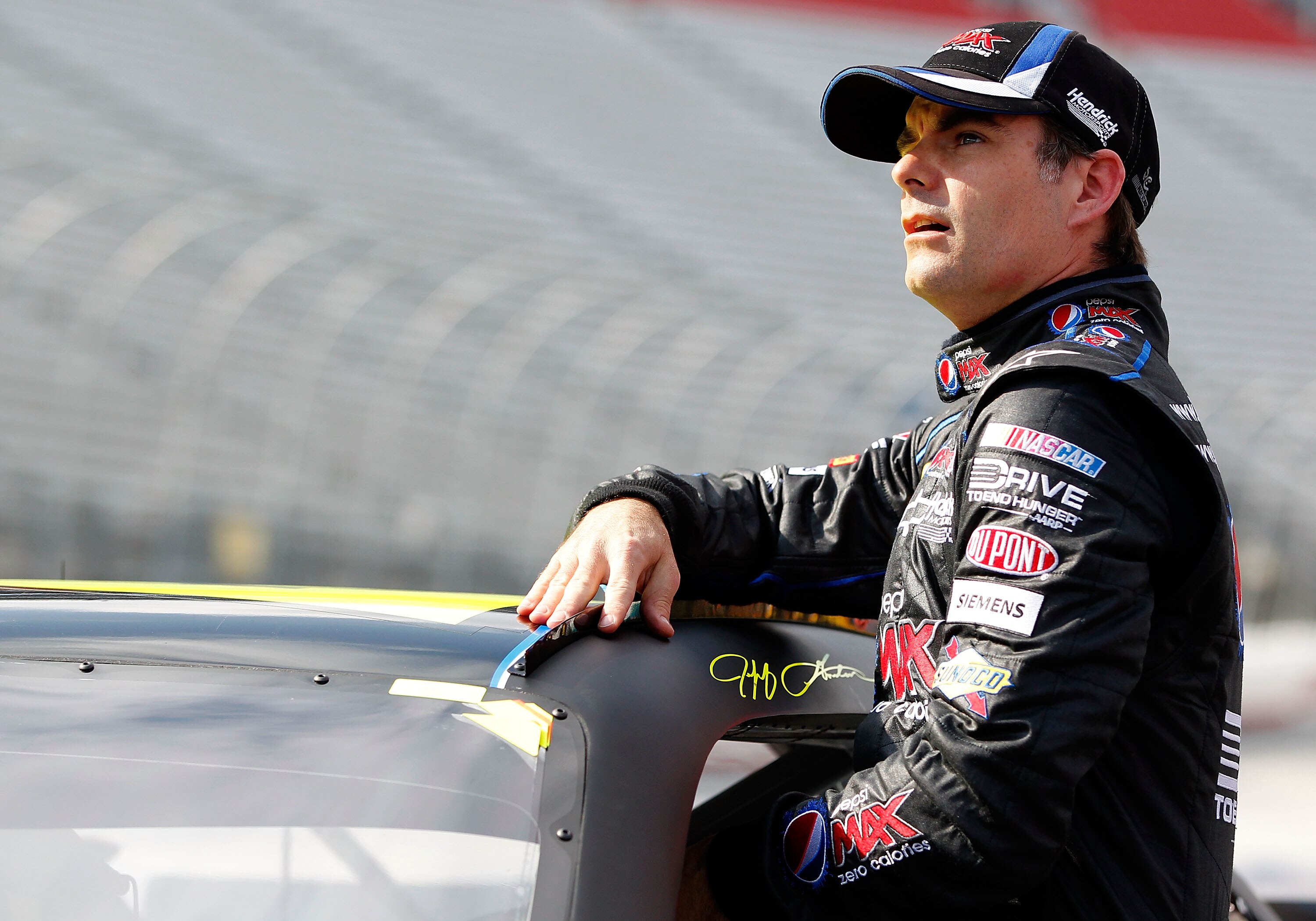 BRISTOL, TN - MARCH 18: Jeff Gordon, driver of the #24 Pepsi MAX Chevrolet, climbs from his car after qualifying for the NASCAR Sprint Cup Series Jeff Byrd 500 Presented By Food City at Bristol Motor Speedway on March 18, 2011 in Bristol, Tennessee.  (Pho