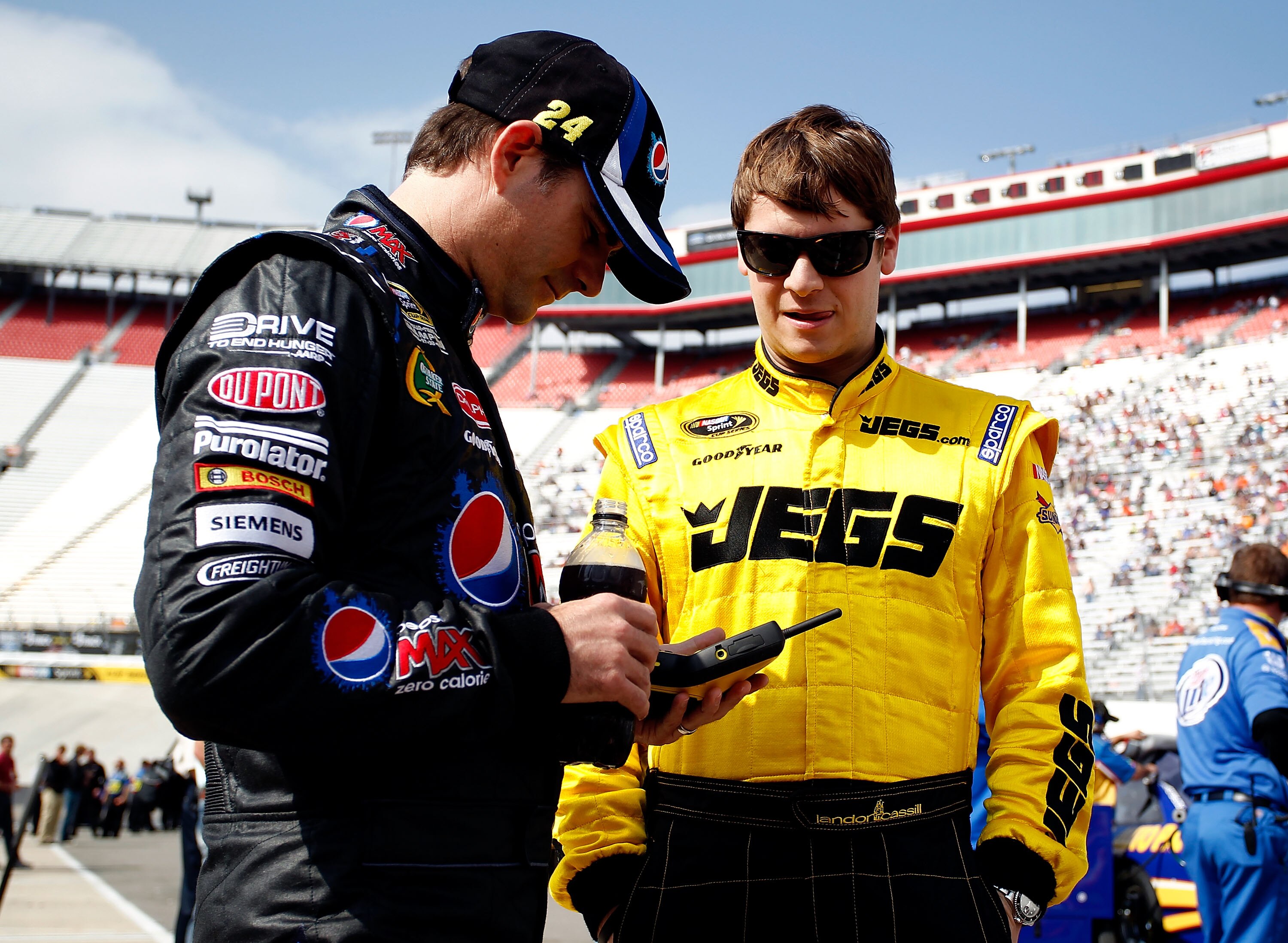 BRISTOL, TN - MARCH 18:  Landon Cassill (R), driver of the #60 Big Red Toyota, talks with Jeff Gordon (L), driver of the #24 Pepsi Max Chevrolet, during qualifying for the NASCAR Sprint Cup Series Jeff Byrd 500 Presented By Food City at Bristol Motor Spee