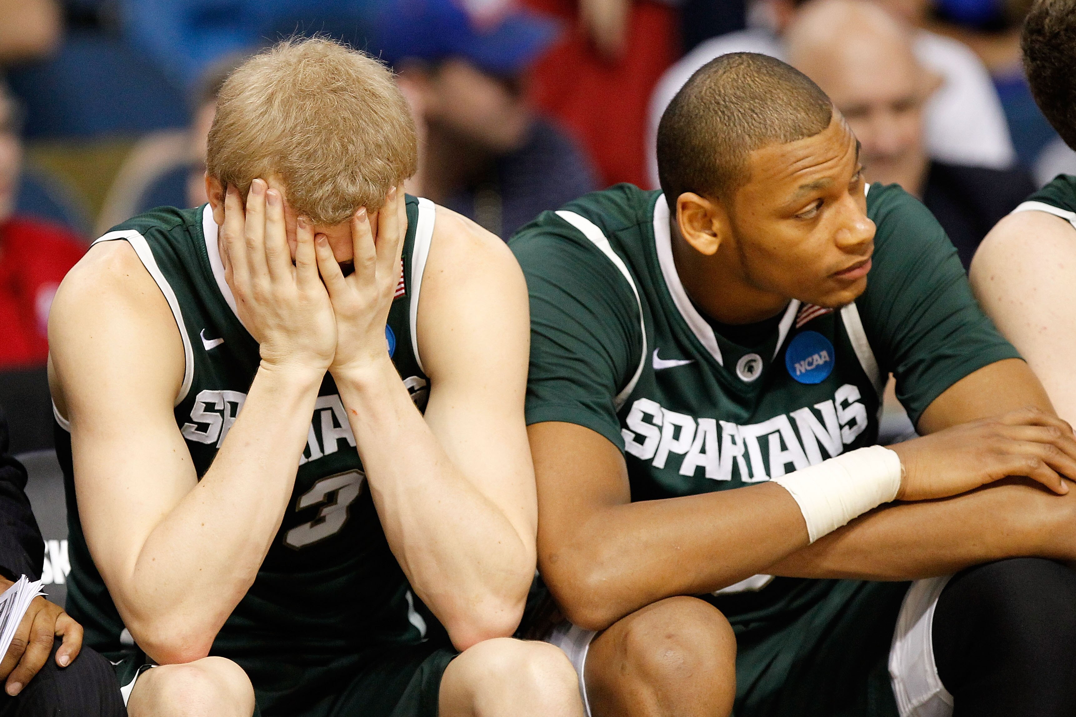 TAMPA, FL - MARCH 17:  (L-R) Austin Thornton #13 and Adreian Payne #5 of the Michigan State Spartans sit on the bench dejected late in the second half of their 78-76 loss against the UCLA Bruins during the second round of the 2011 NCAA men's basketball to
